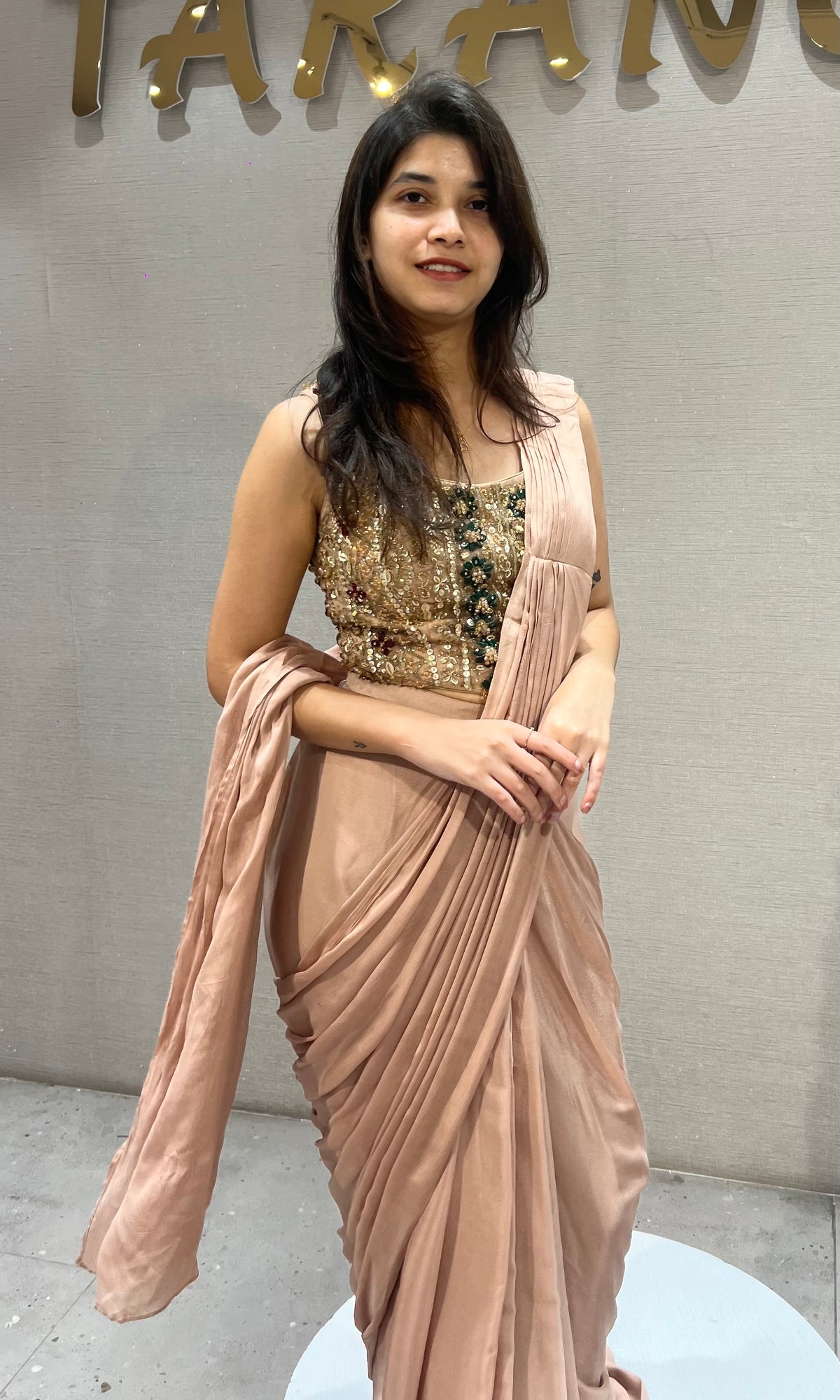 Dusty Georgette drape saree with gold & emerald green detailing blouse
