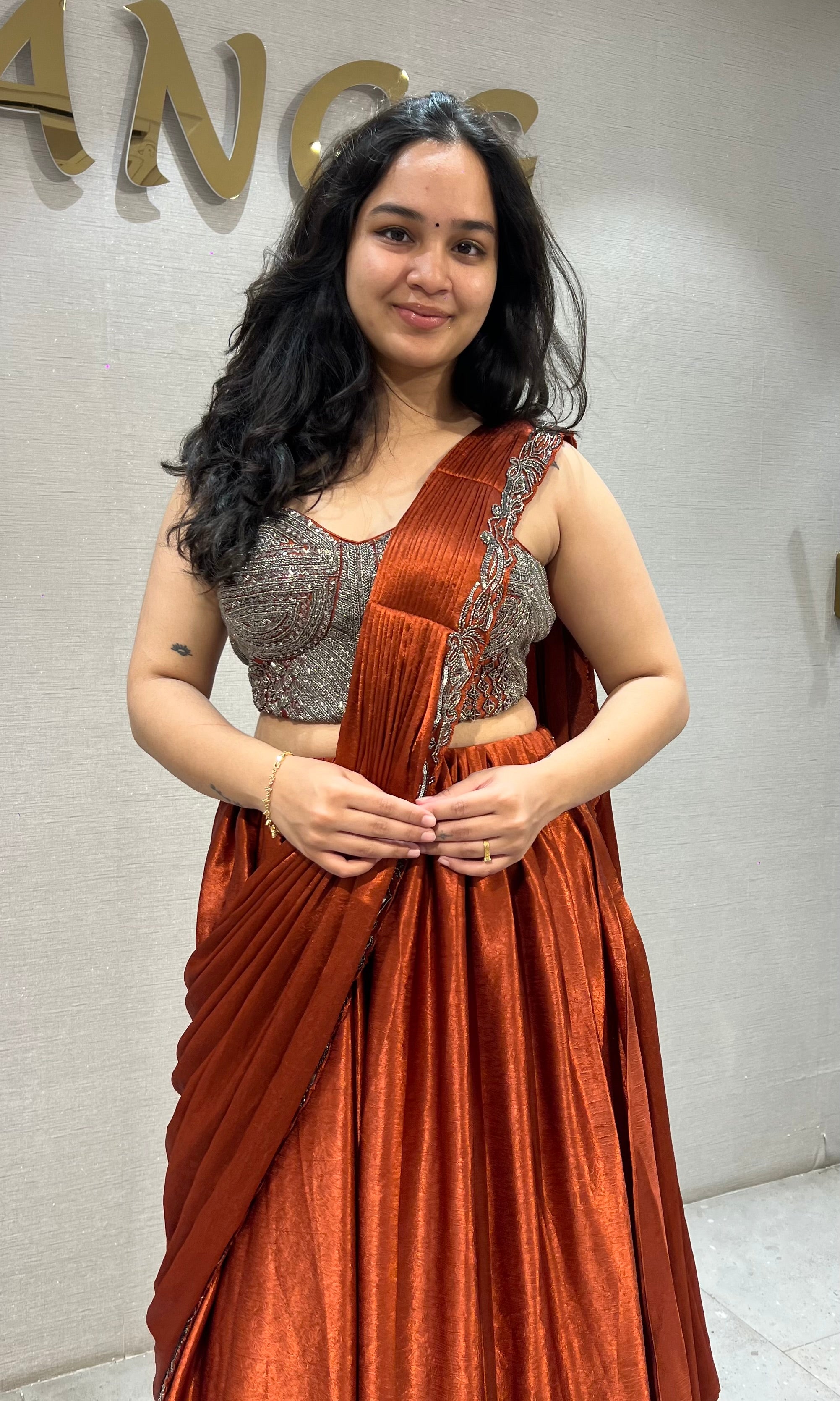 Rust Orange satin Draped lehenga with Silver embroidered Blouse