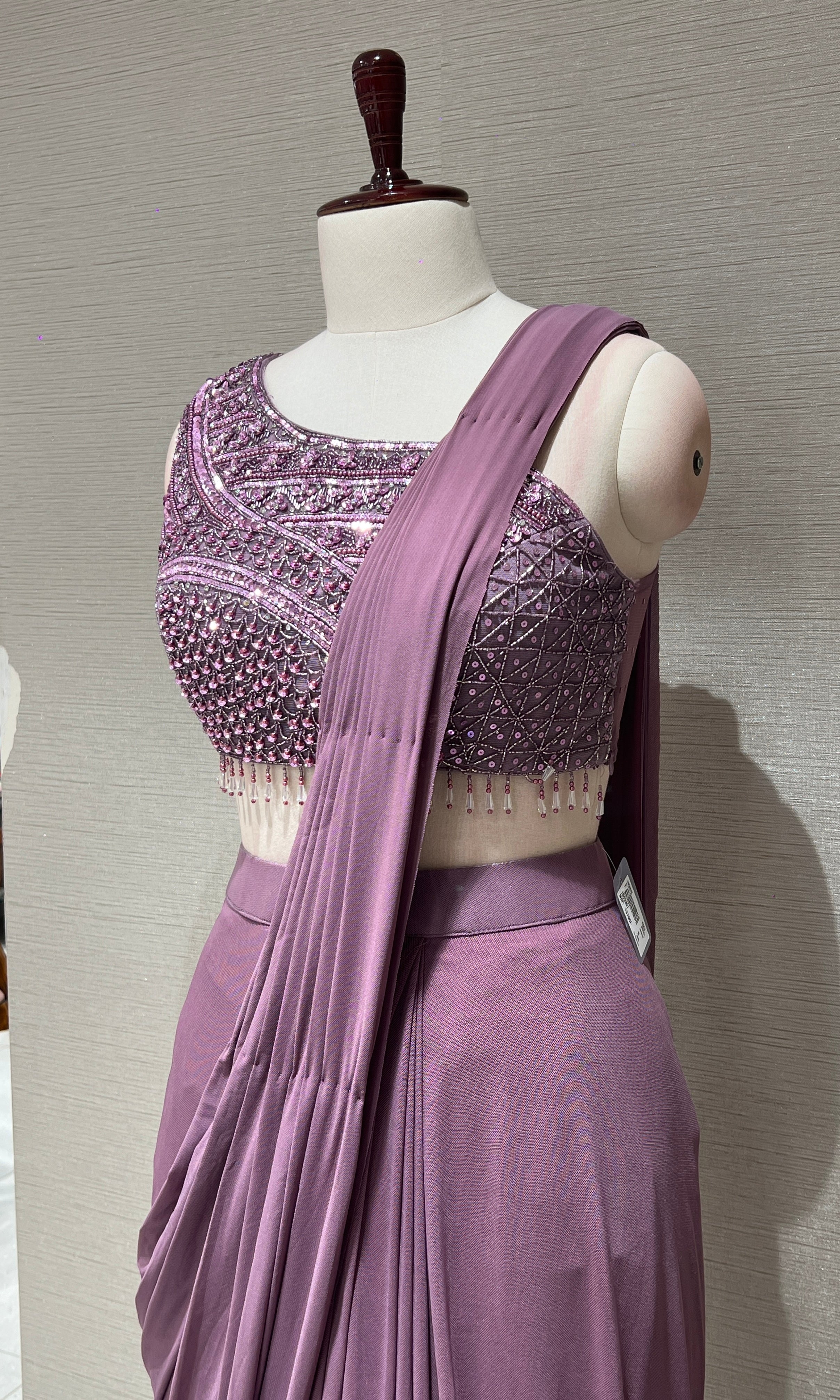 purple drape saree with asymmetrical blouse