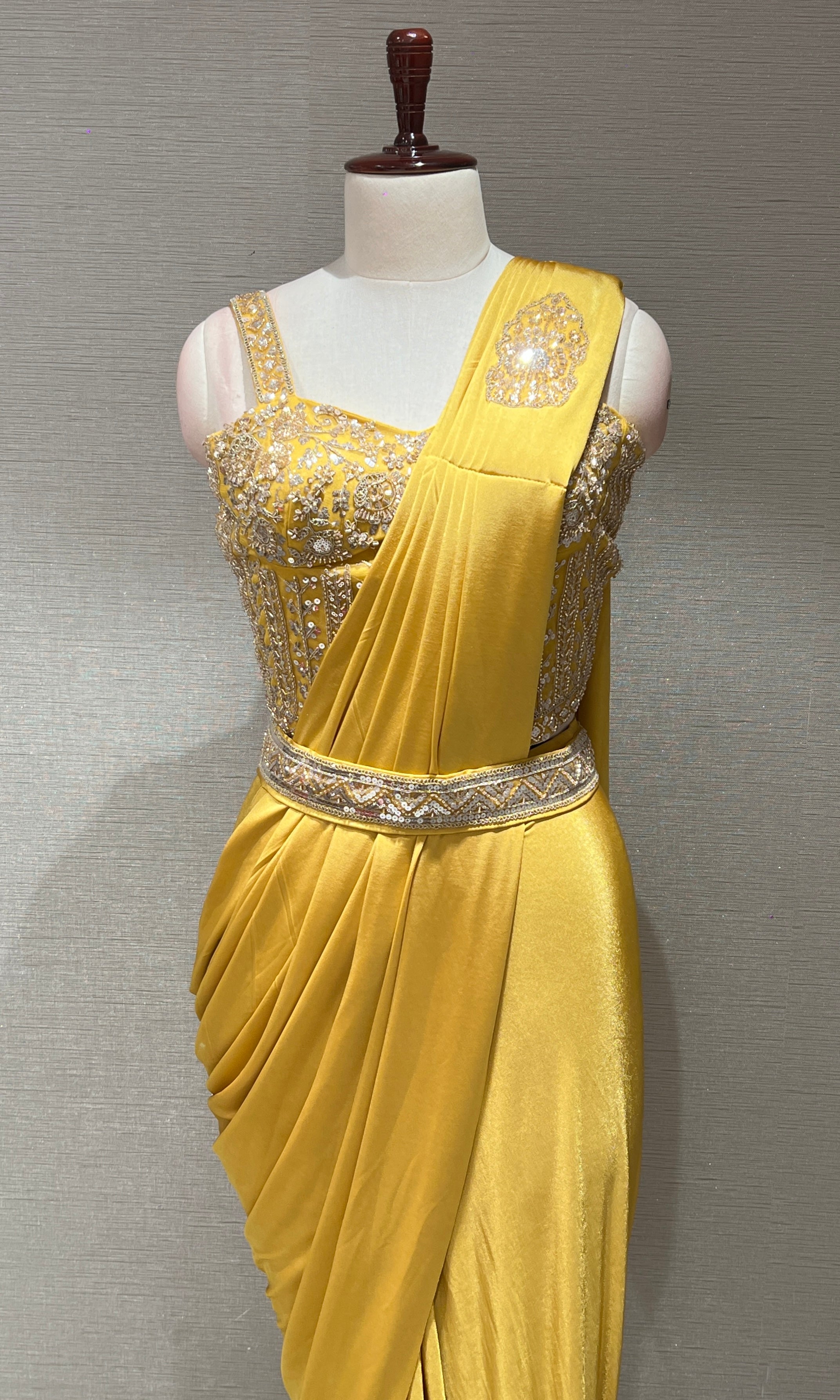 yellow drape saree with corset blouse and belt