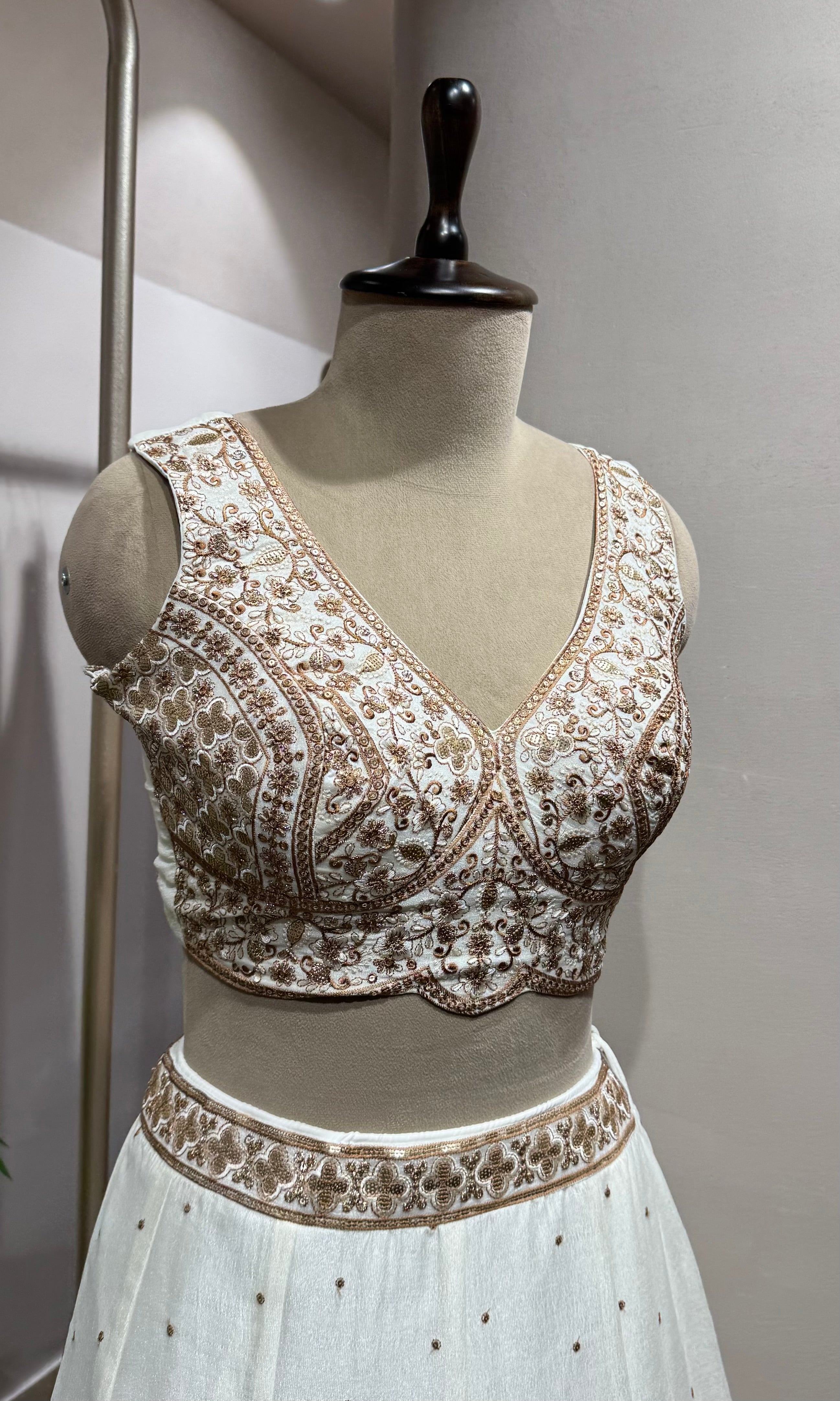 White Lehenga with gold embellished blouse