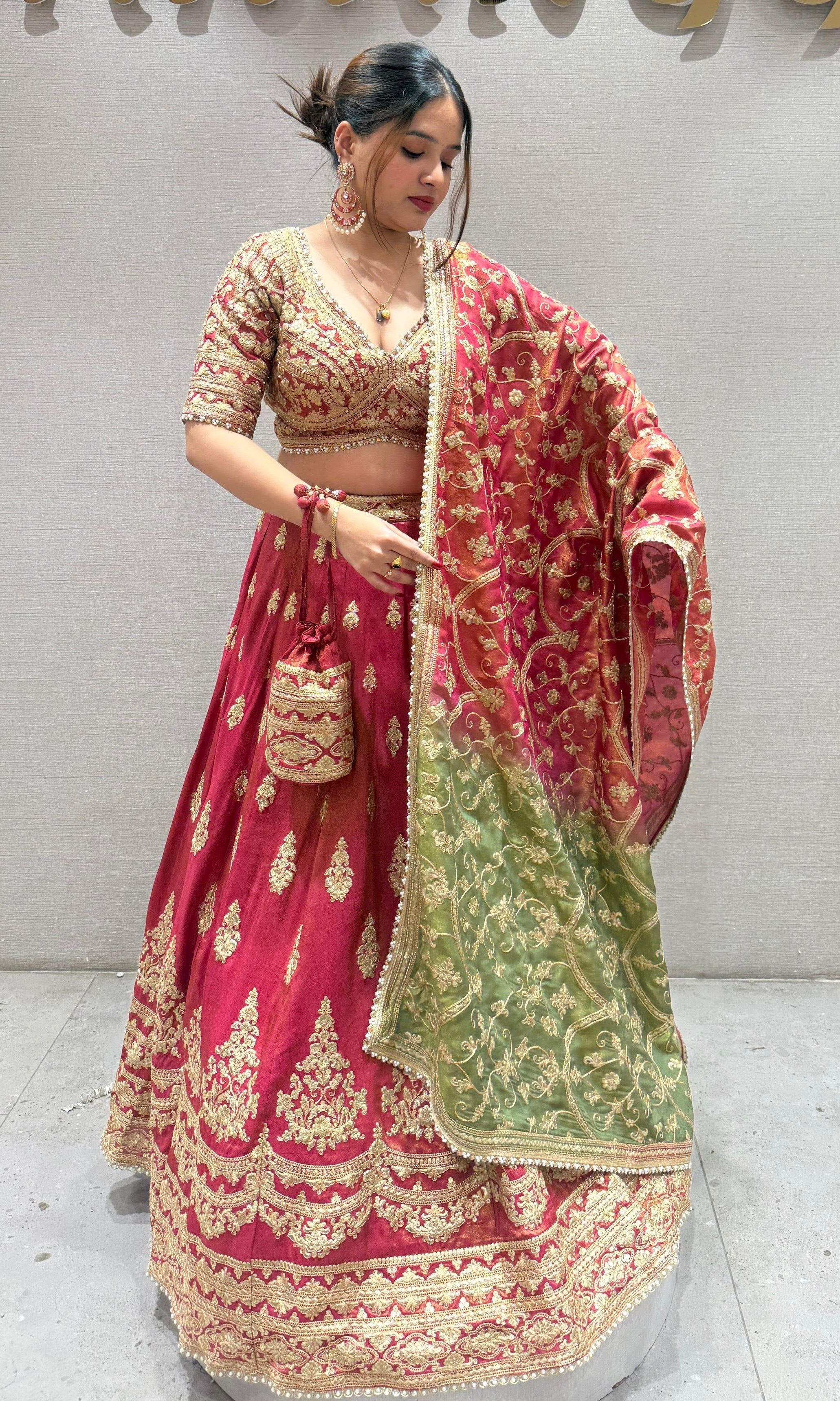 Brick red and green Lehenga with potli