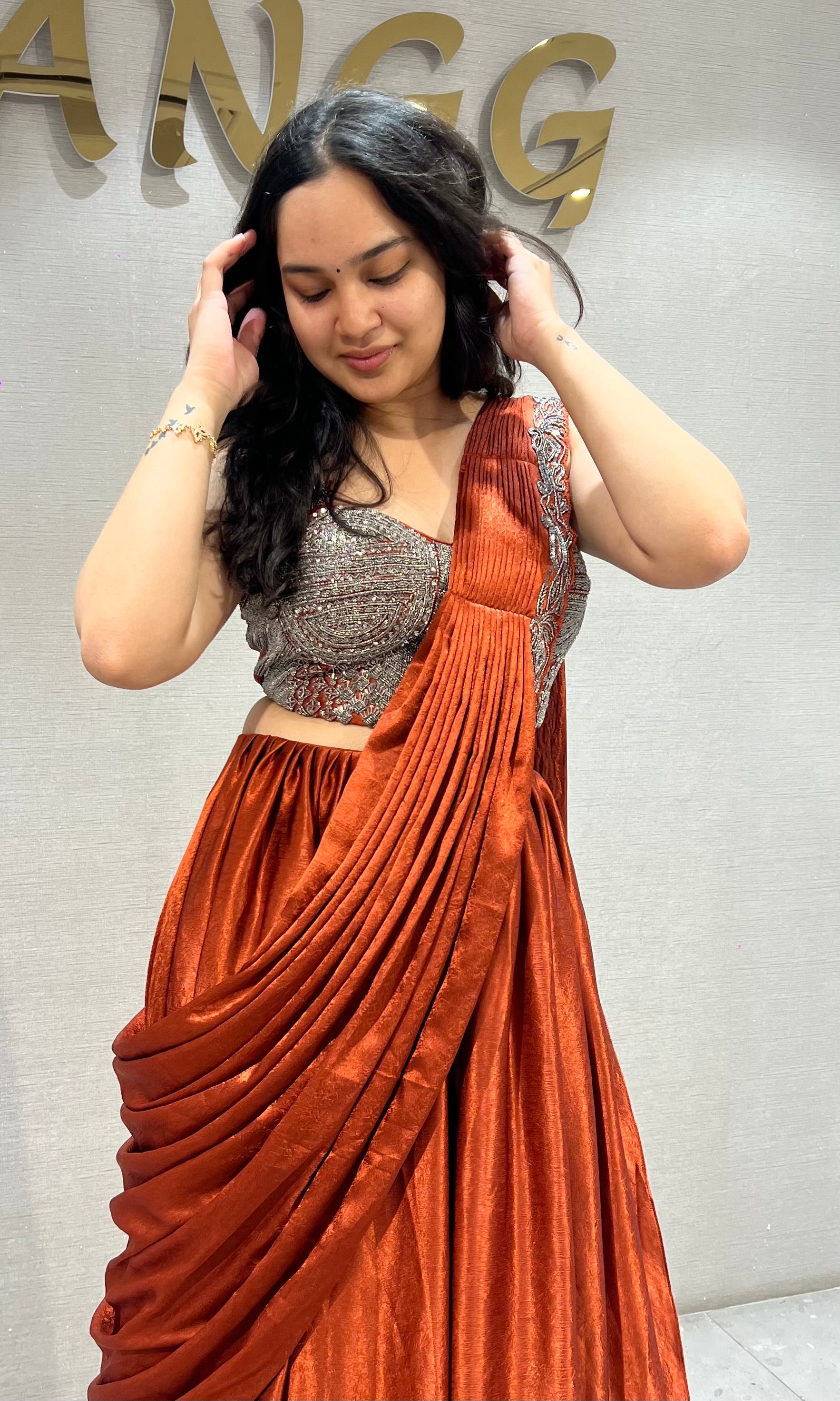 Rust Orange satin Draped lehenga with Silver embroidered Blouse