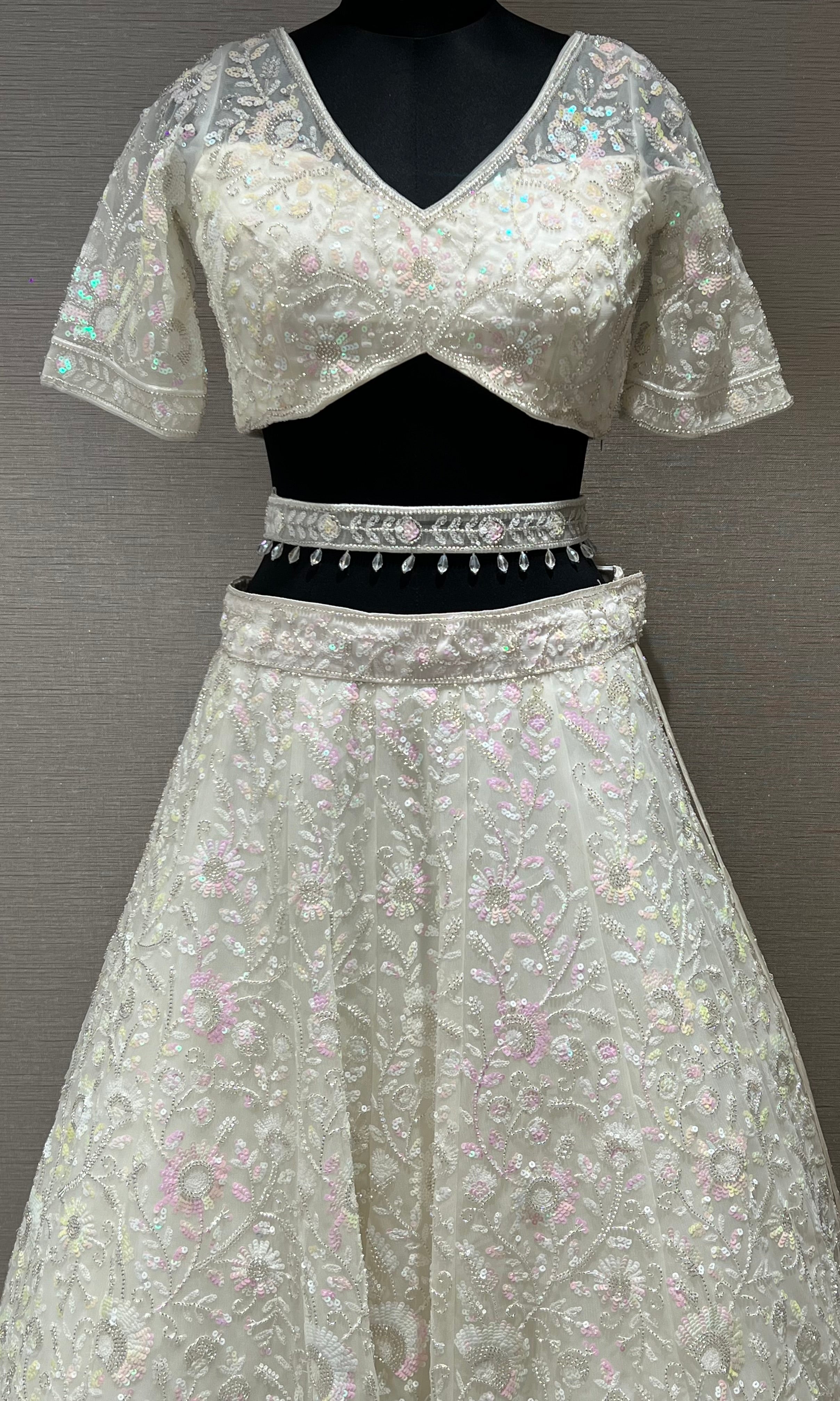 White beautiful work Lehenga with pretty blouse and netted dupatta