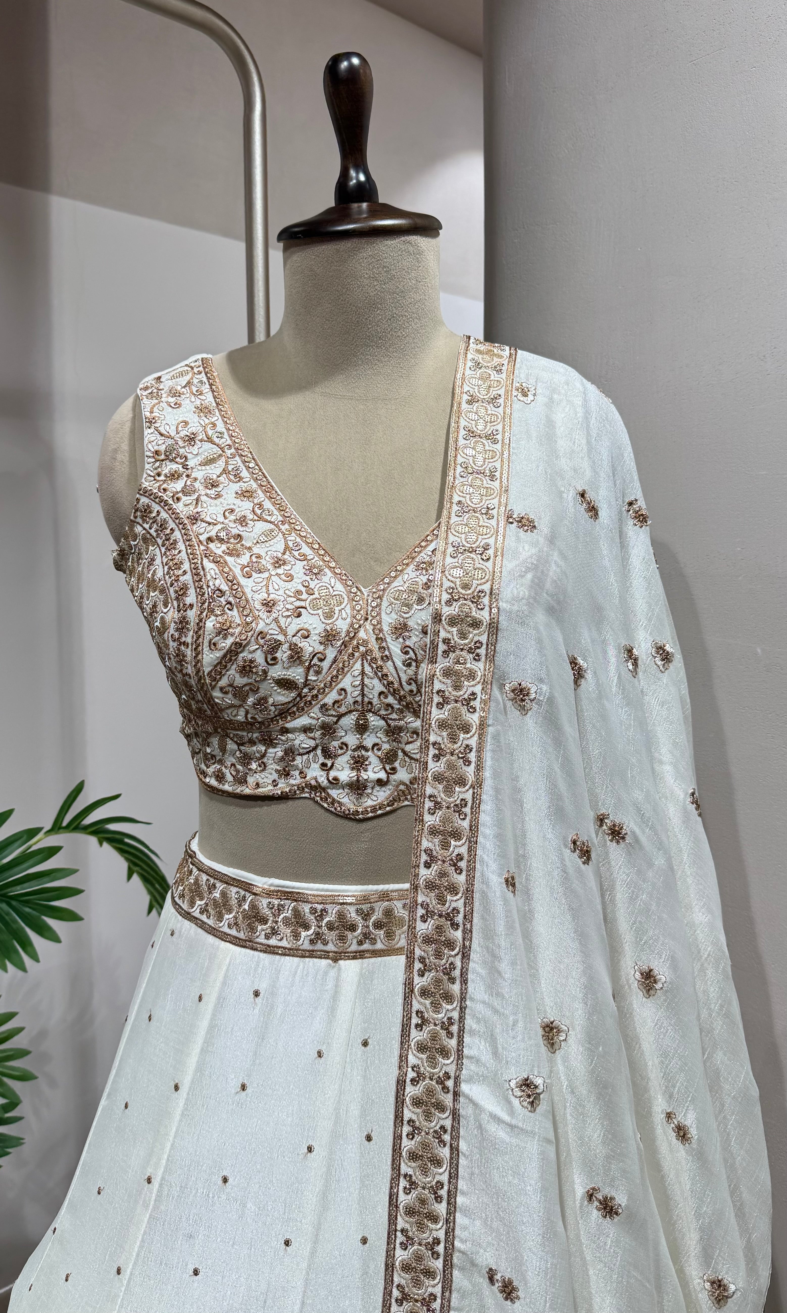 White Lehenga with gold embellished blouse