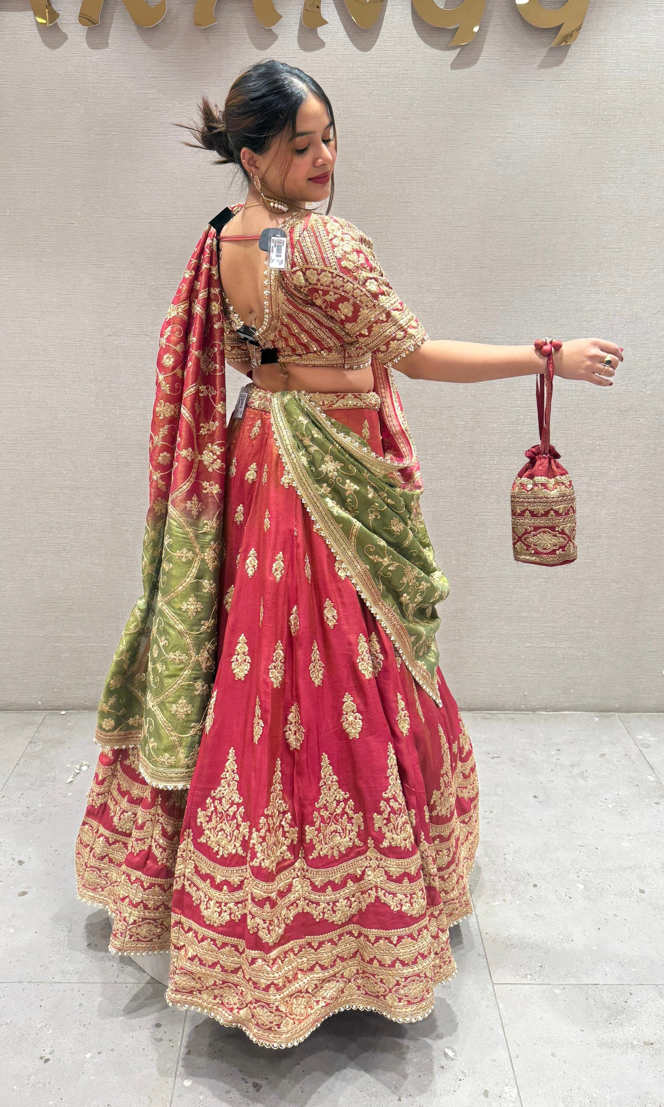 Brick red and green Lehenga with potli