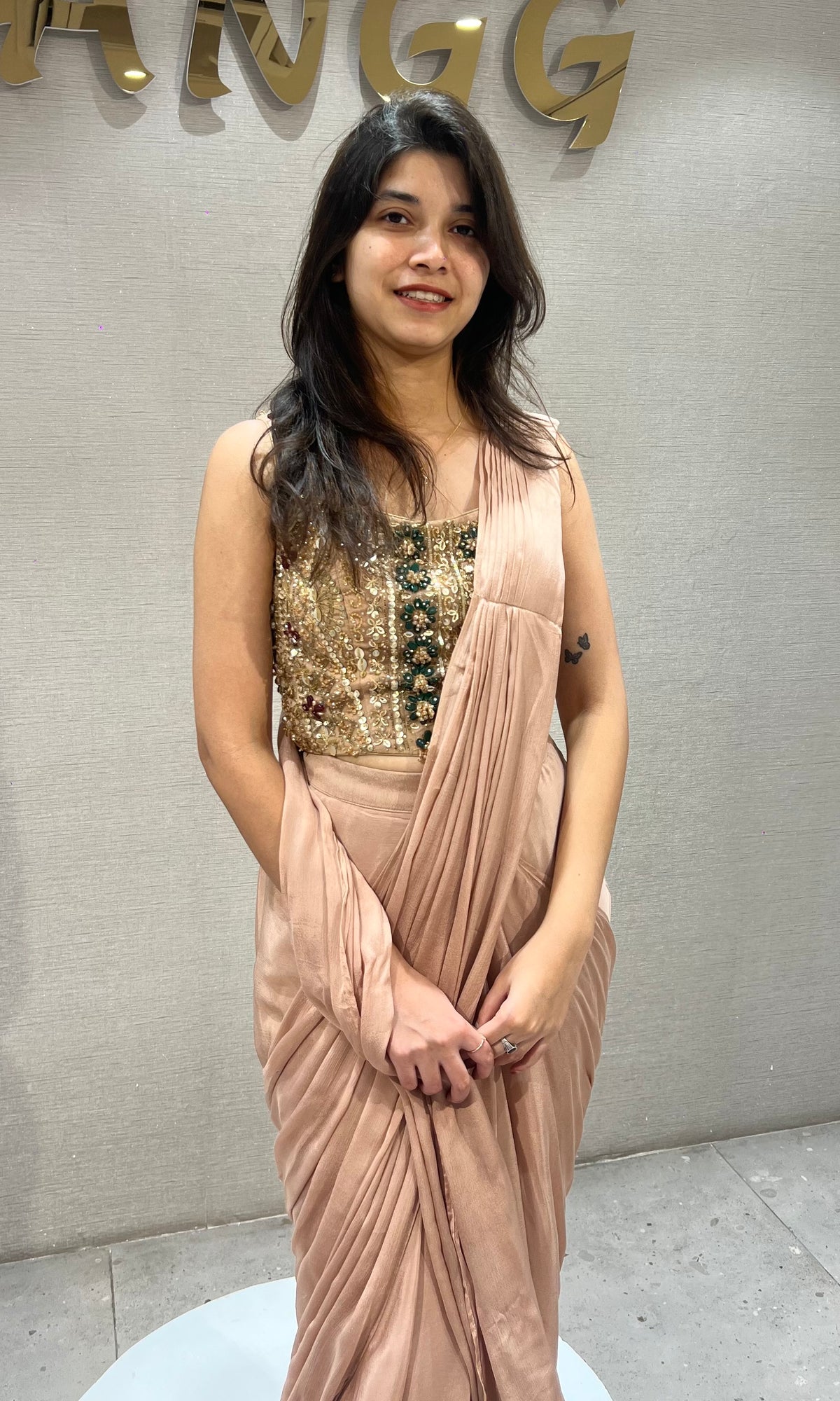 Dusty Georgette drape saree with gold & emerald green detailing blouse