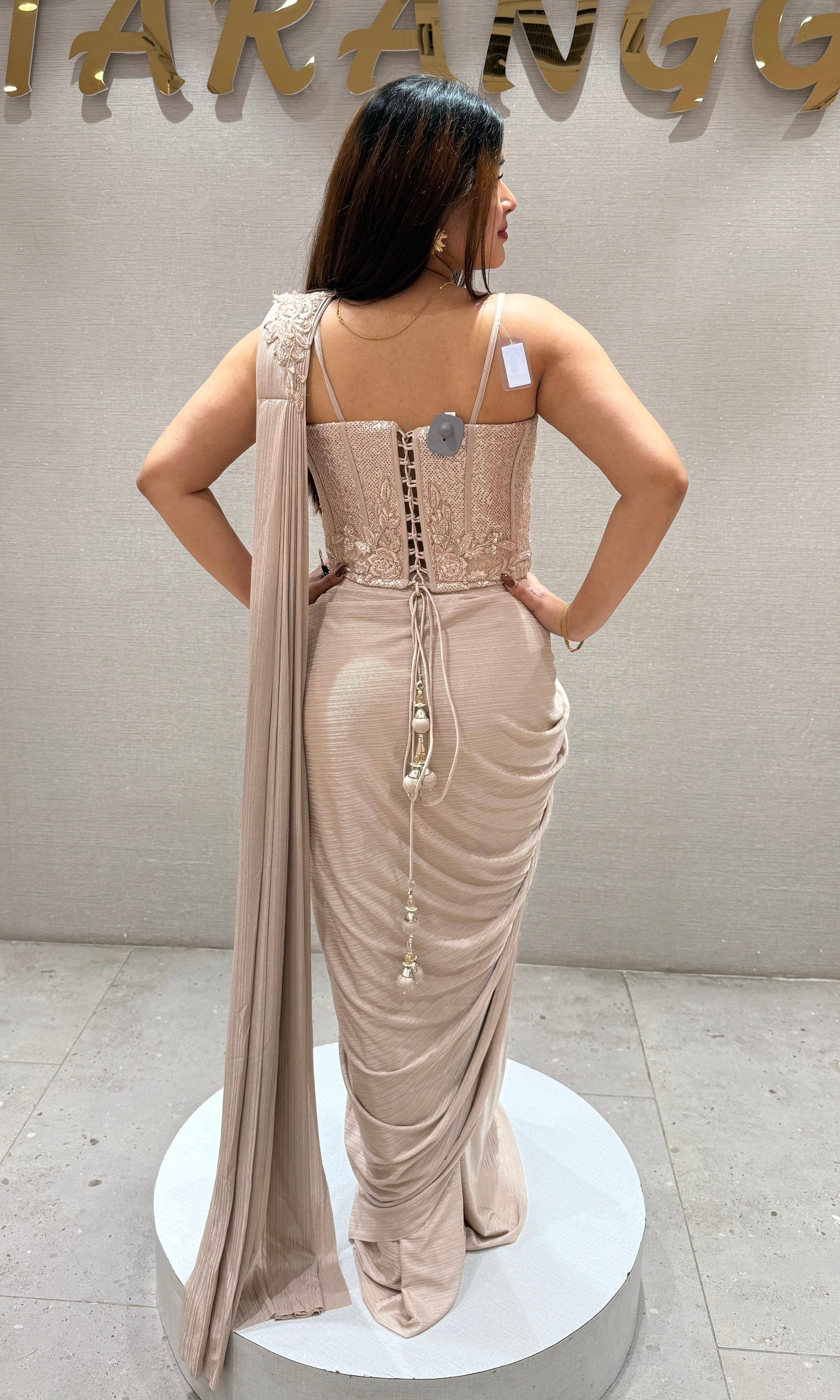 Beige drape saree with corset blouse