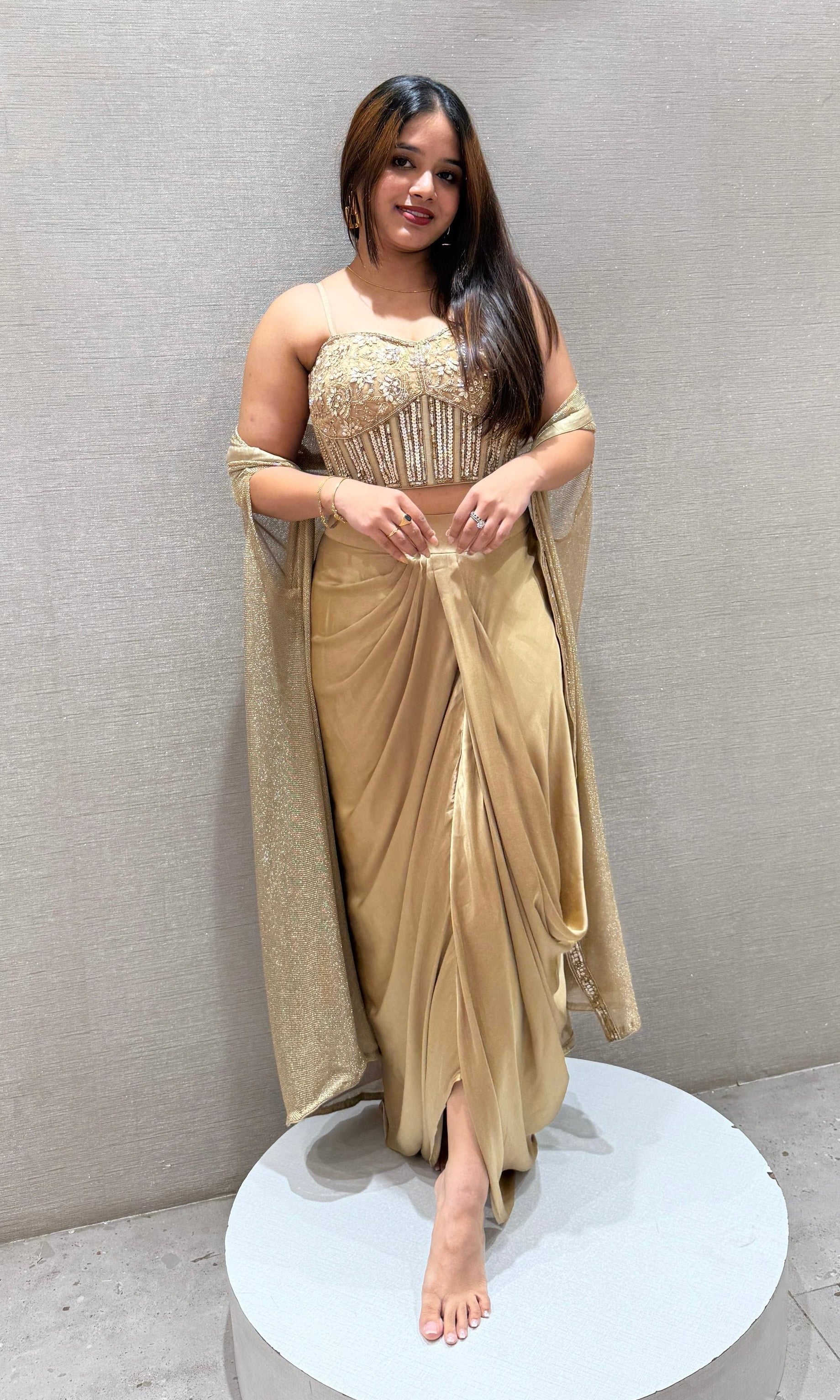 Golden sequined crop top with dhoti skirt and cape