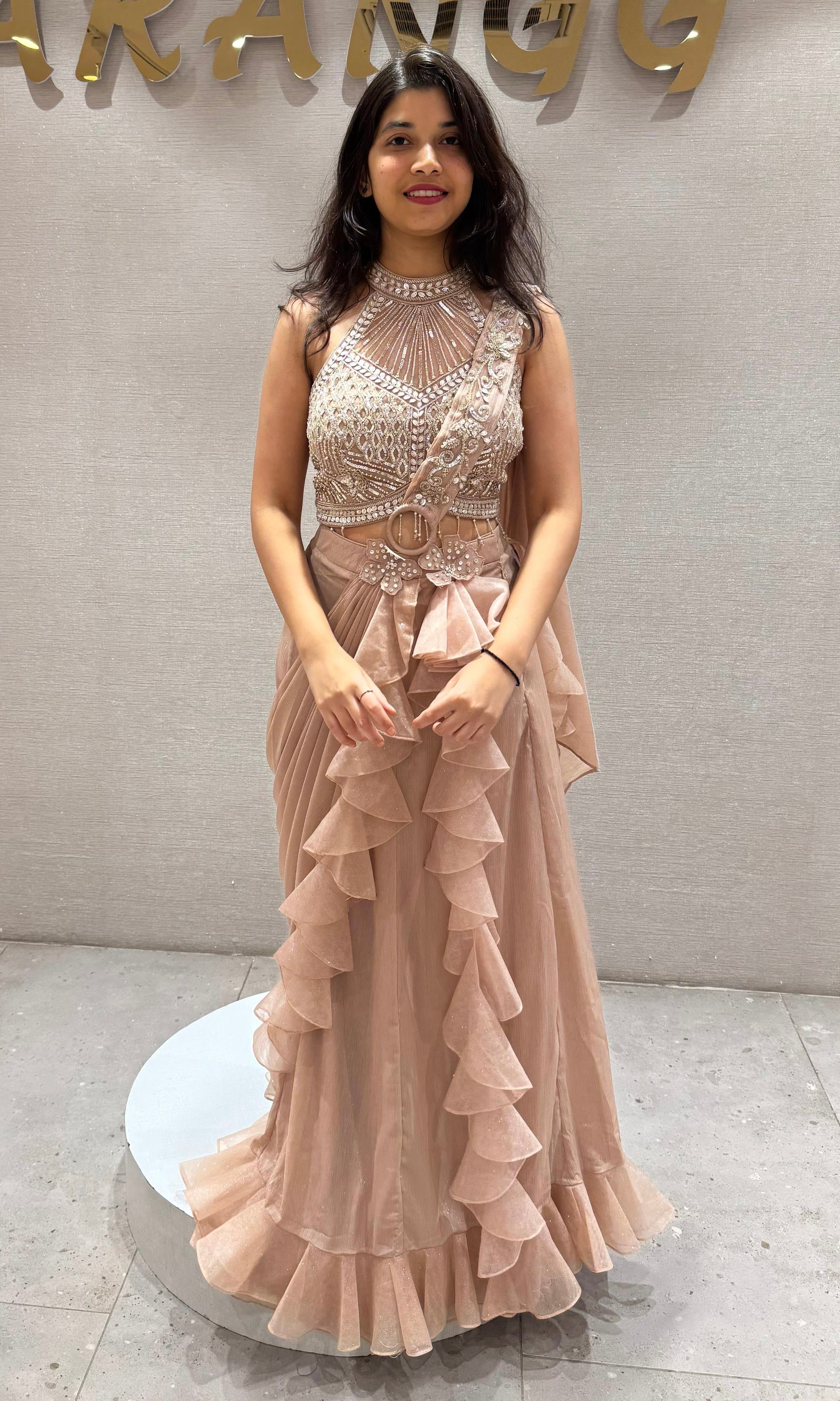 Beige drape saree with ruffles and embellished blouse