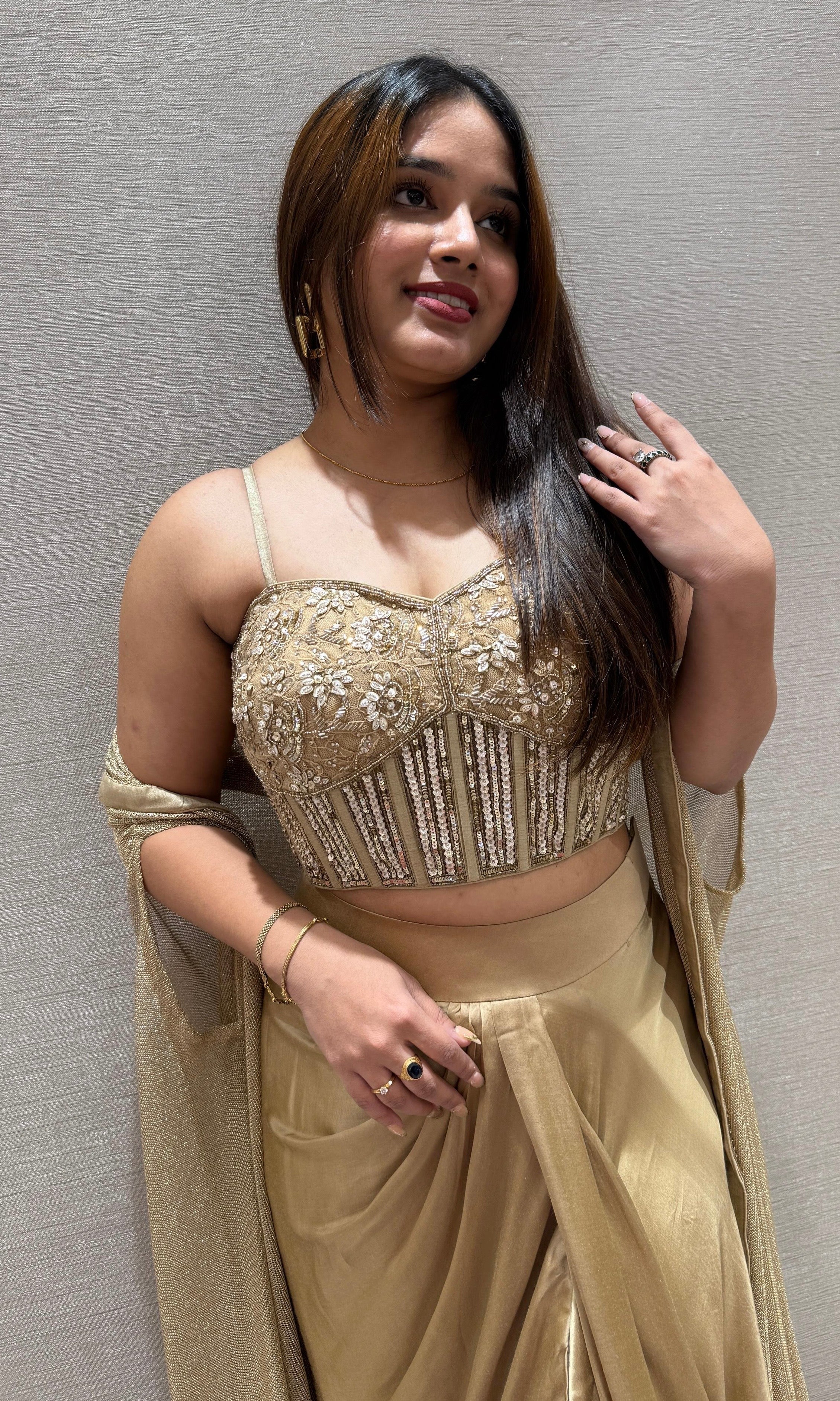 Golden sequined crop top with dhoti skirt and cape