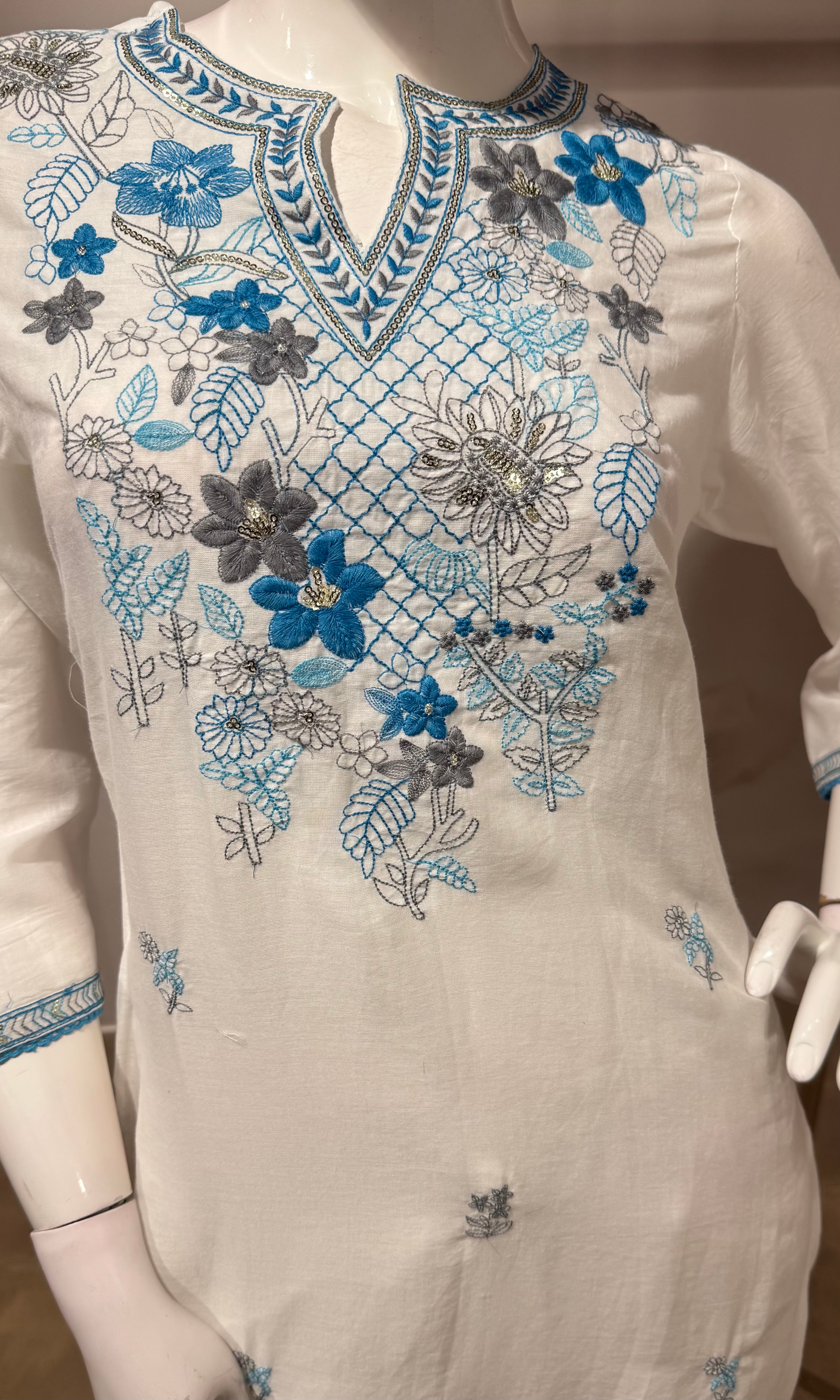 white kurta set features blue floral embroidery