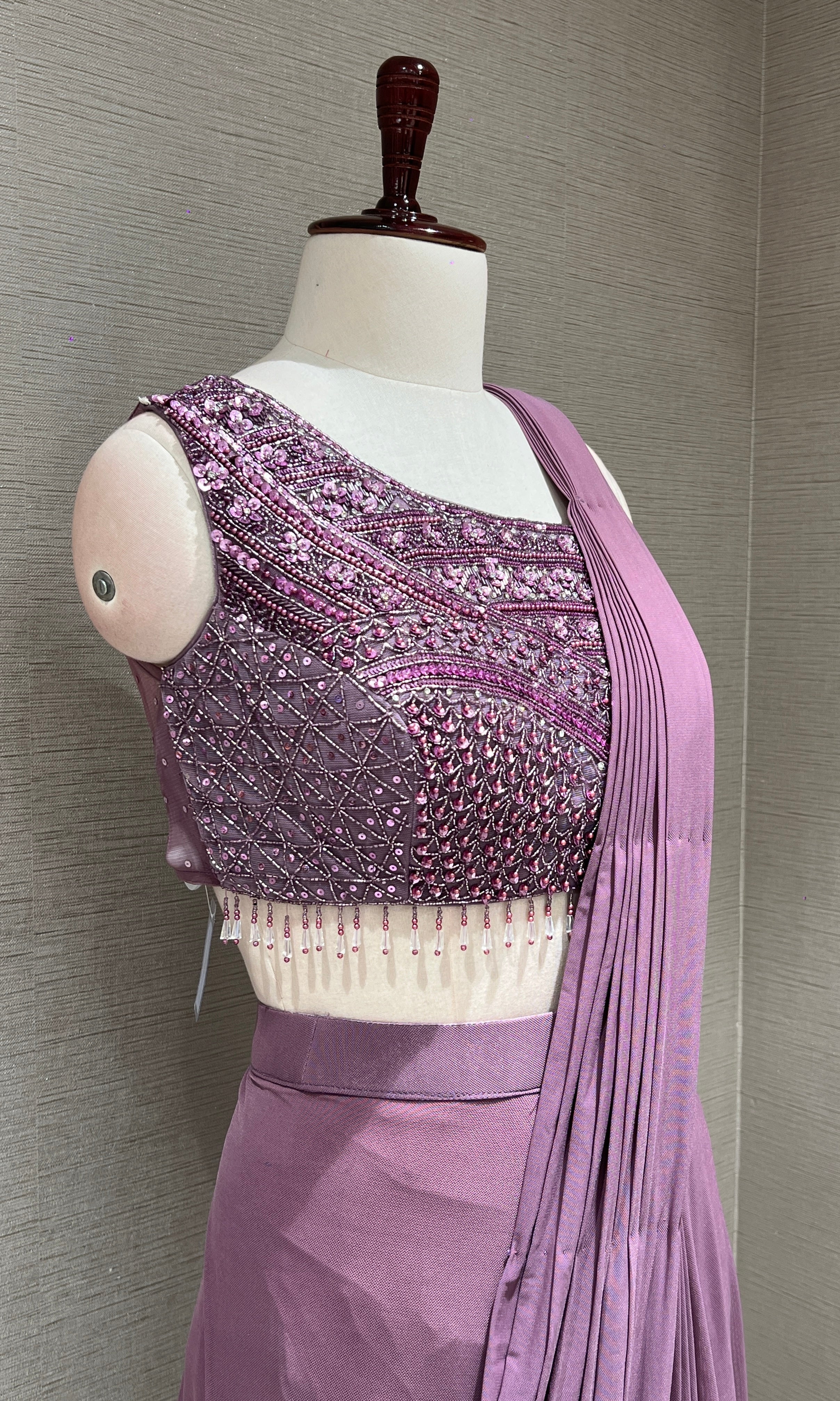 purple drape saree with asymmetrical blouse