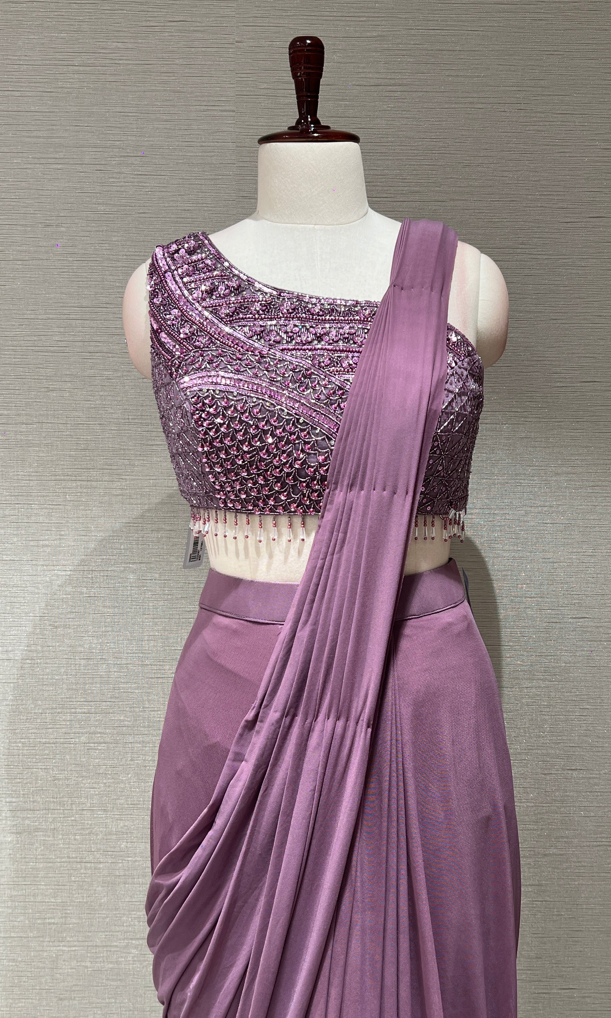 purple drape saree with asymmetrical blouse