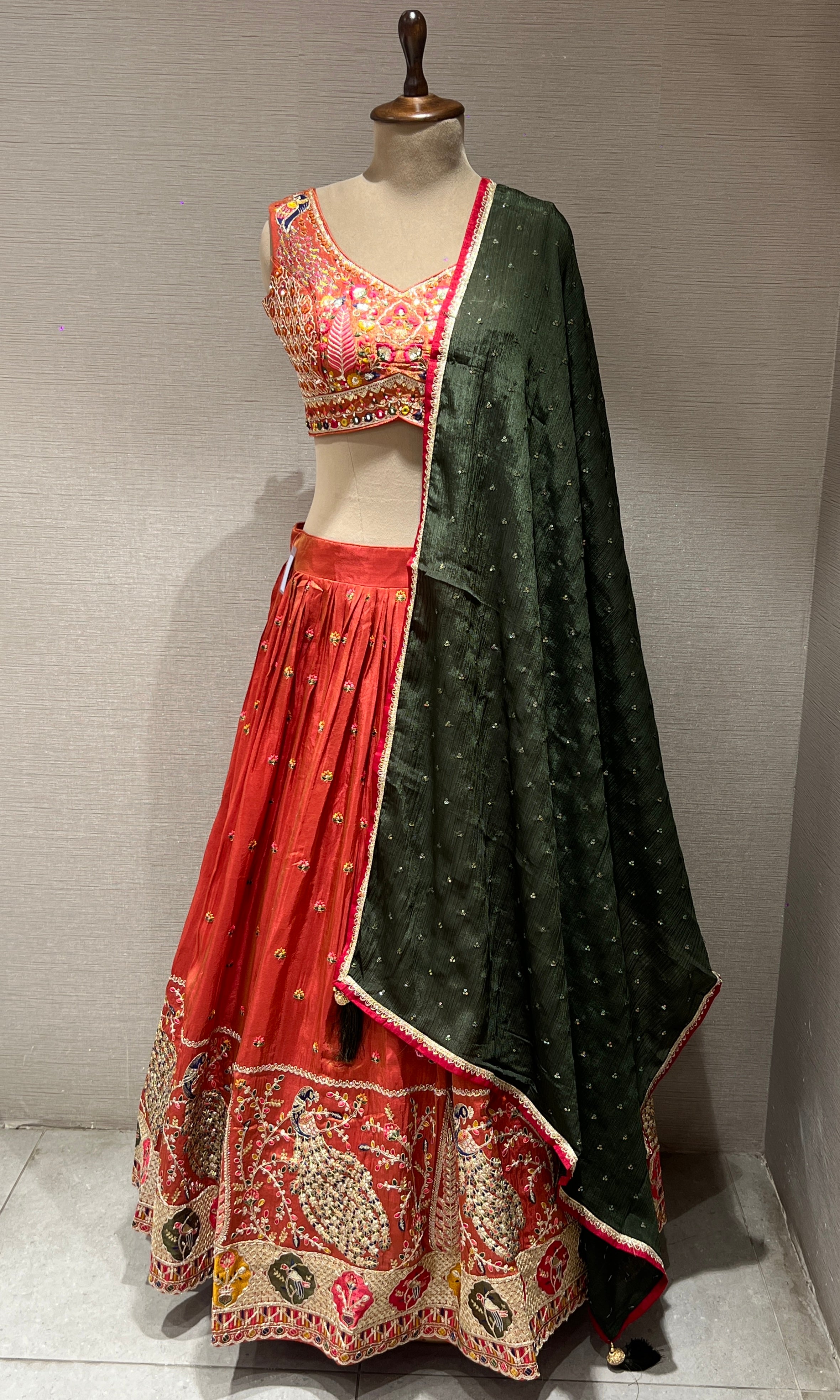 Rust and green embroidered lehenga choli
