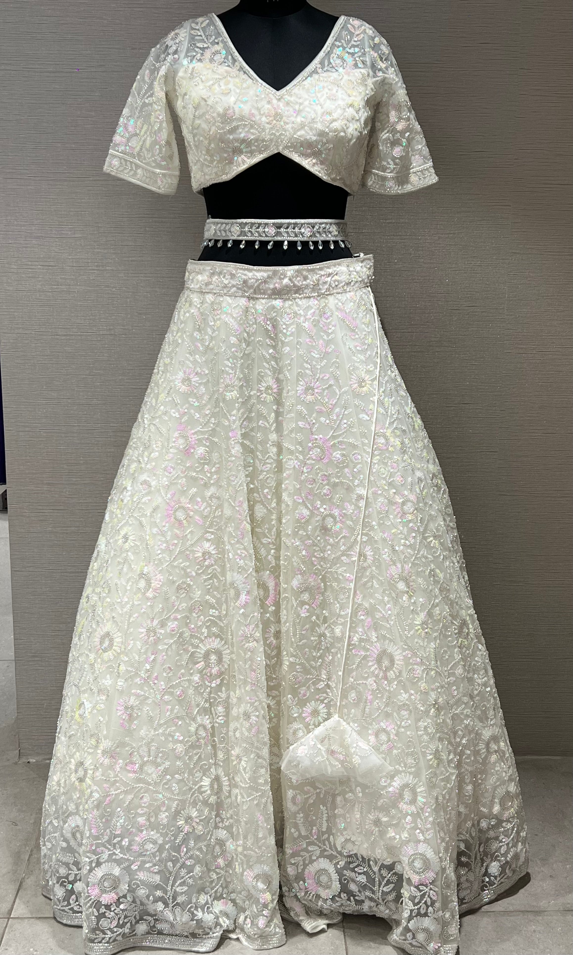 White beautiful work Lehenga with pretty blouse and netted dupatta