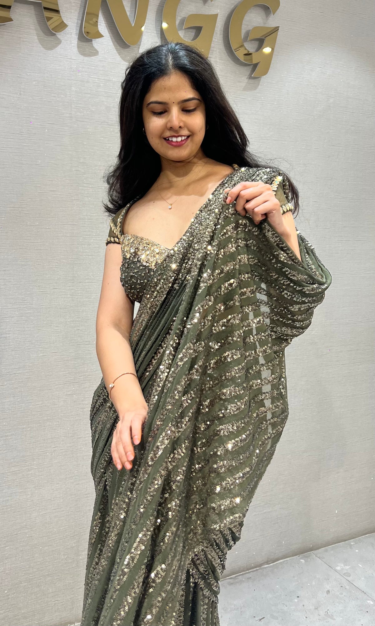 green shimmer metallic drape saree with embellished blouse
