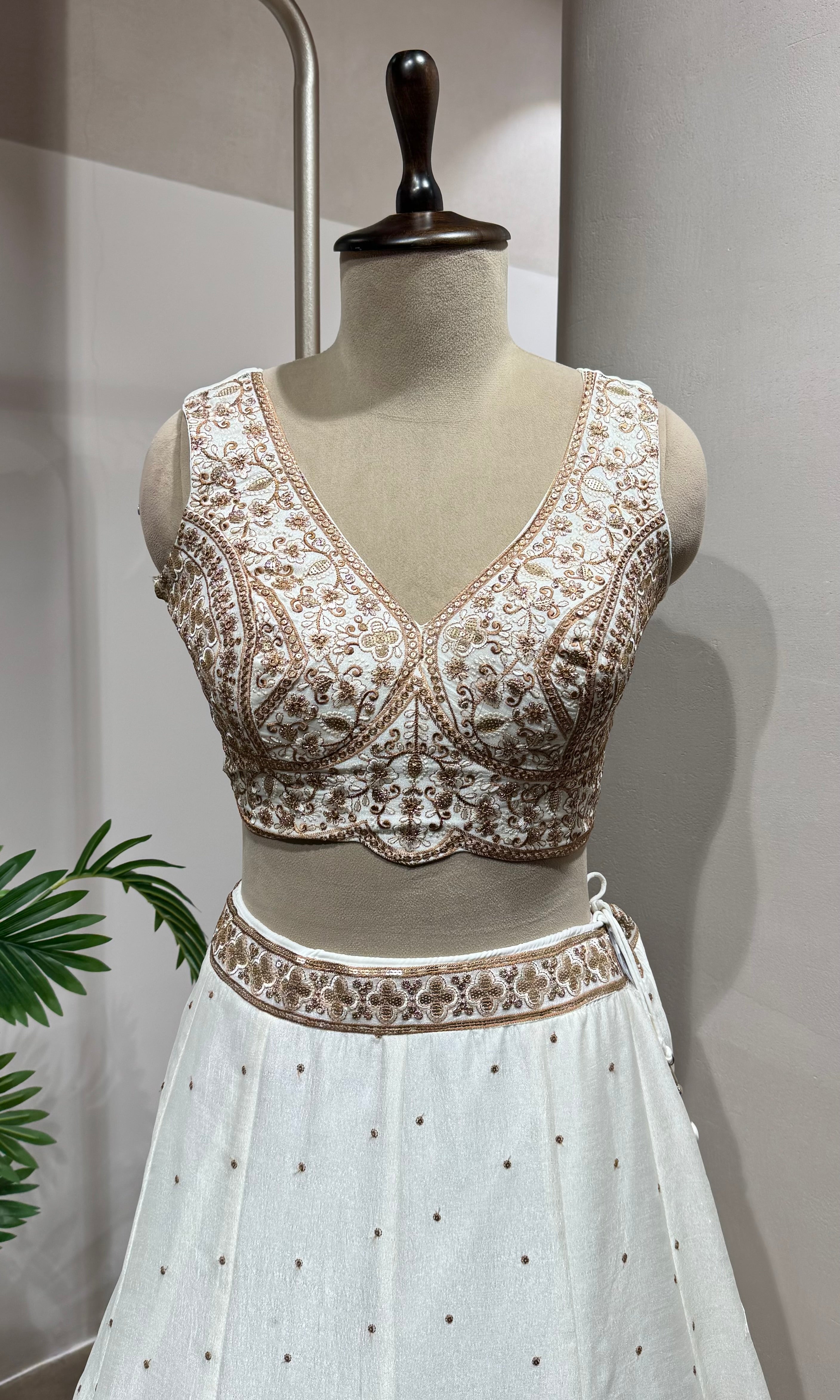 White Lehenga with gold embellished blouse