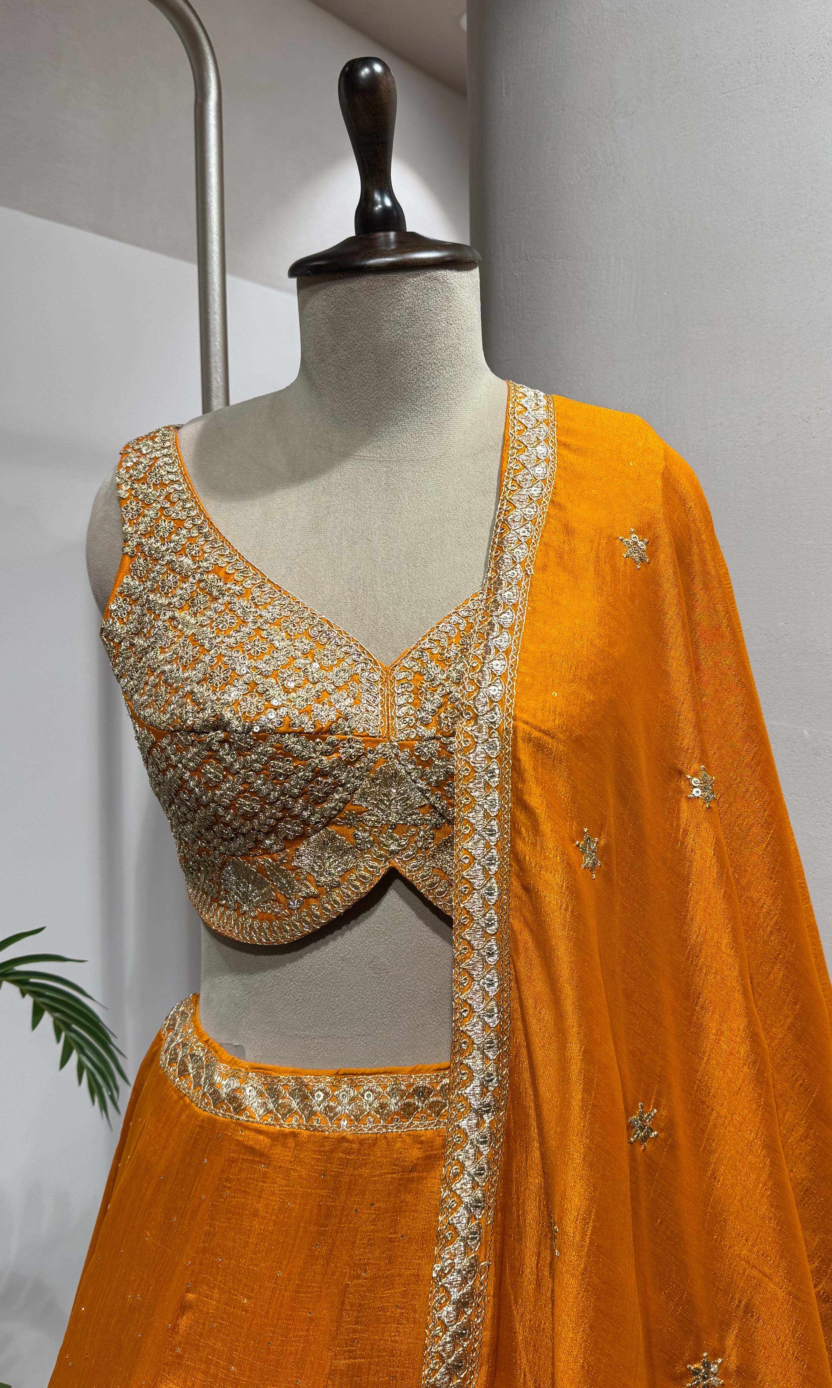 orange silk lehenga set with gold embroidery