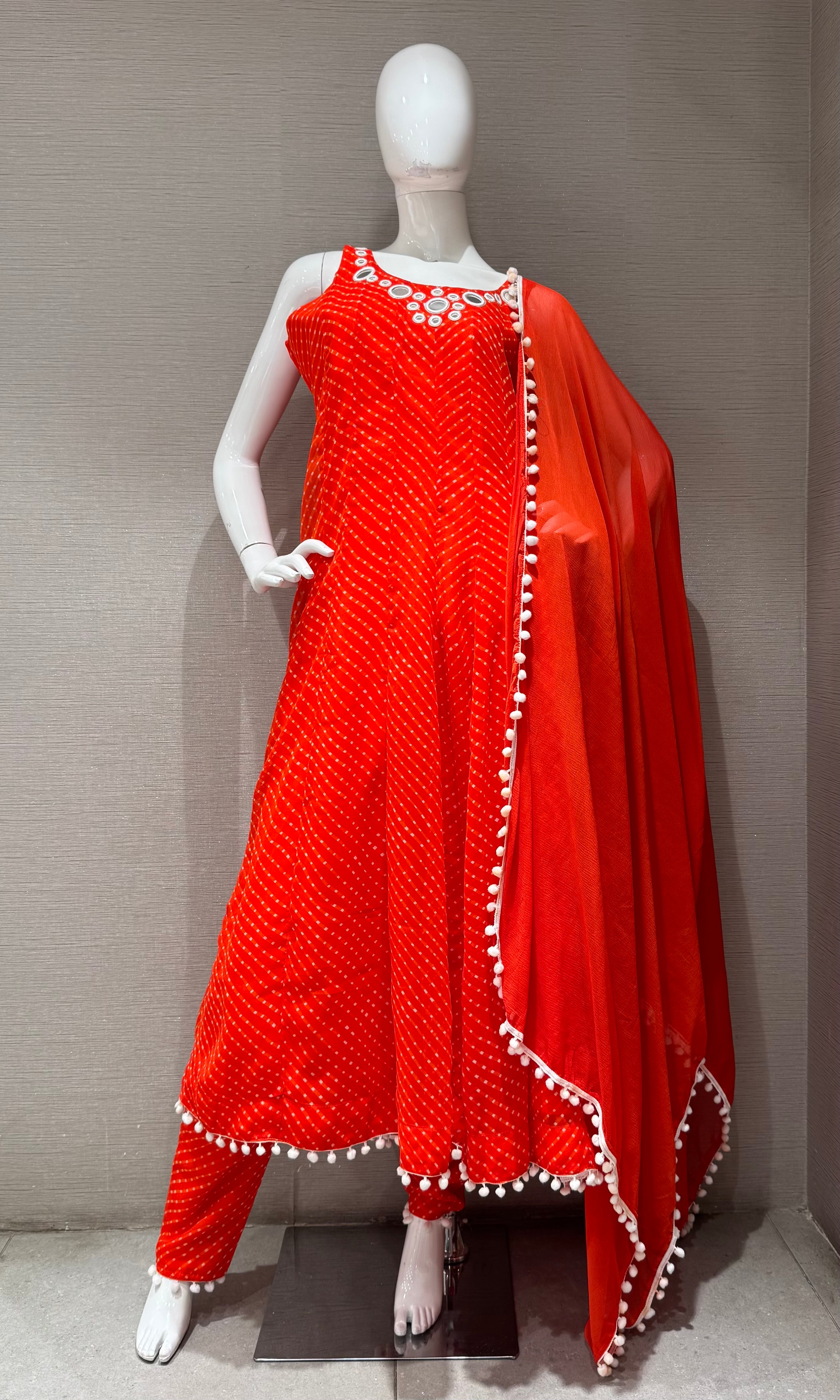 Orange bandhani print and intricate mirror anarkali set