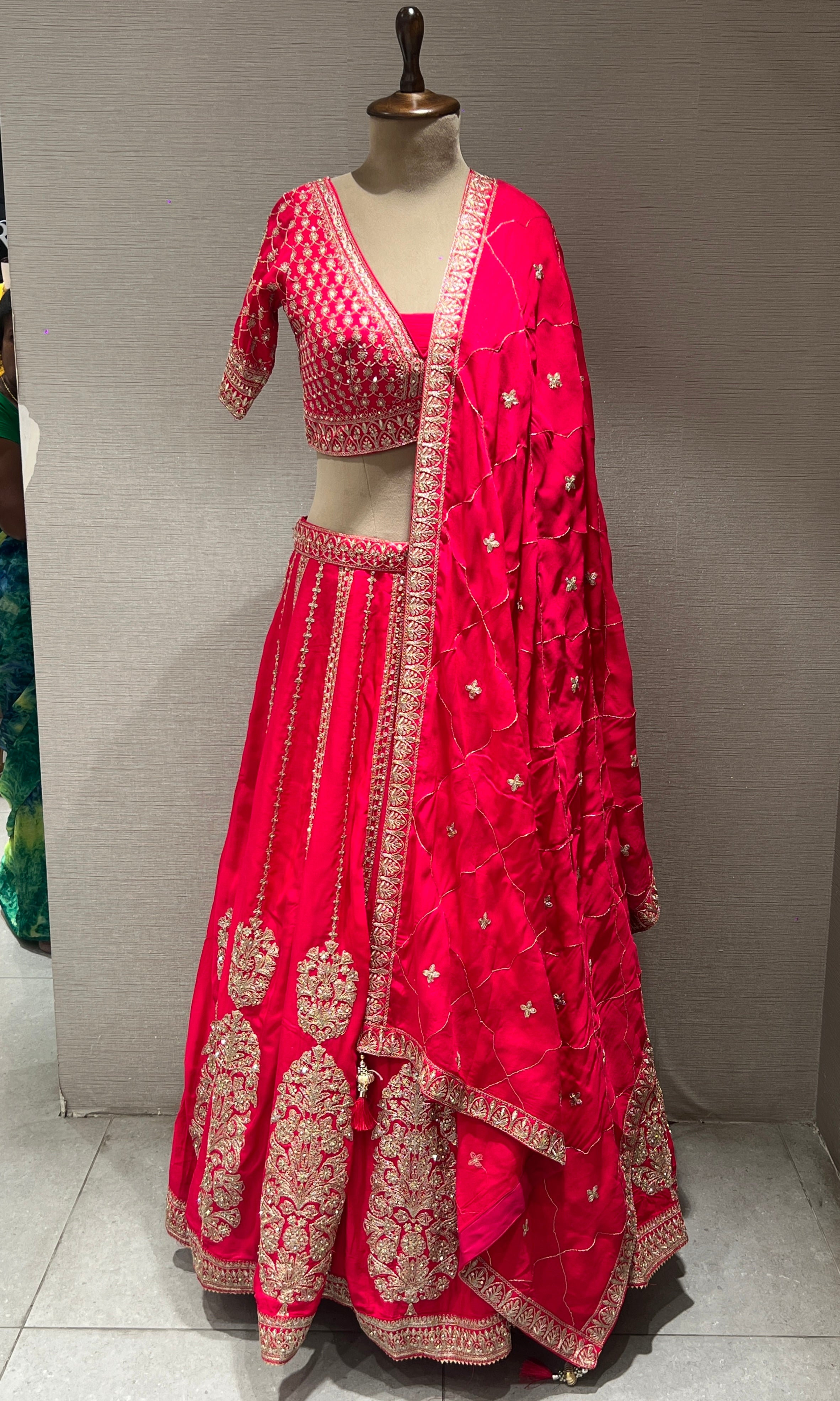 rani pink lehenga with intricate embroidery