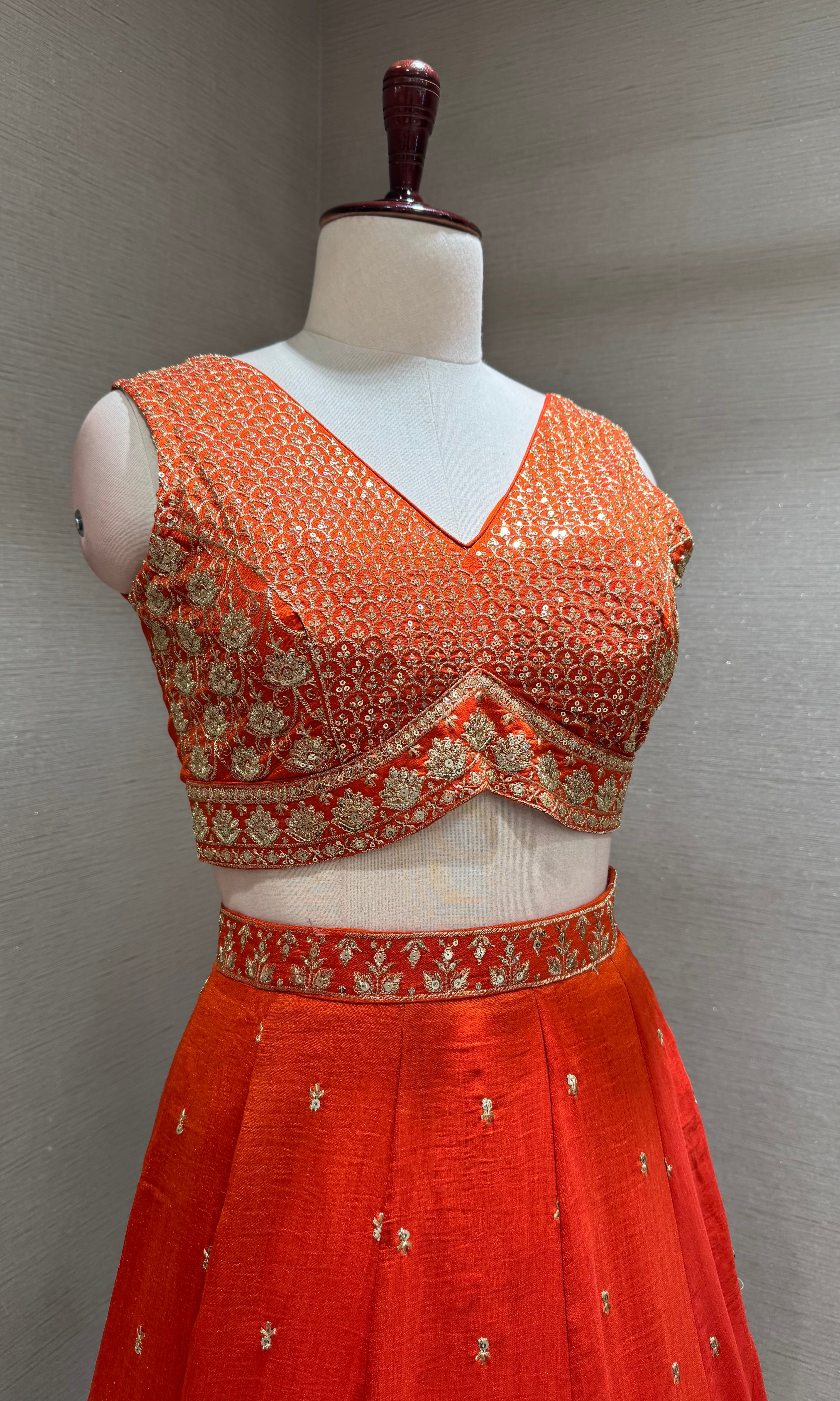 Orange Silk Lehenga Choli with Intricate Gold Borders