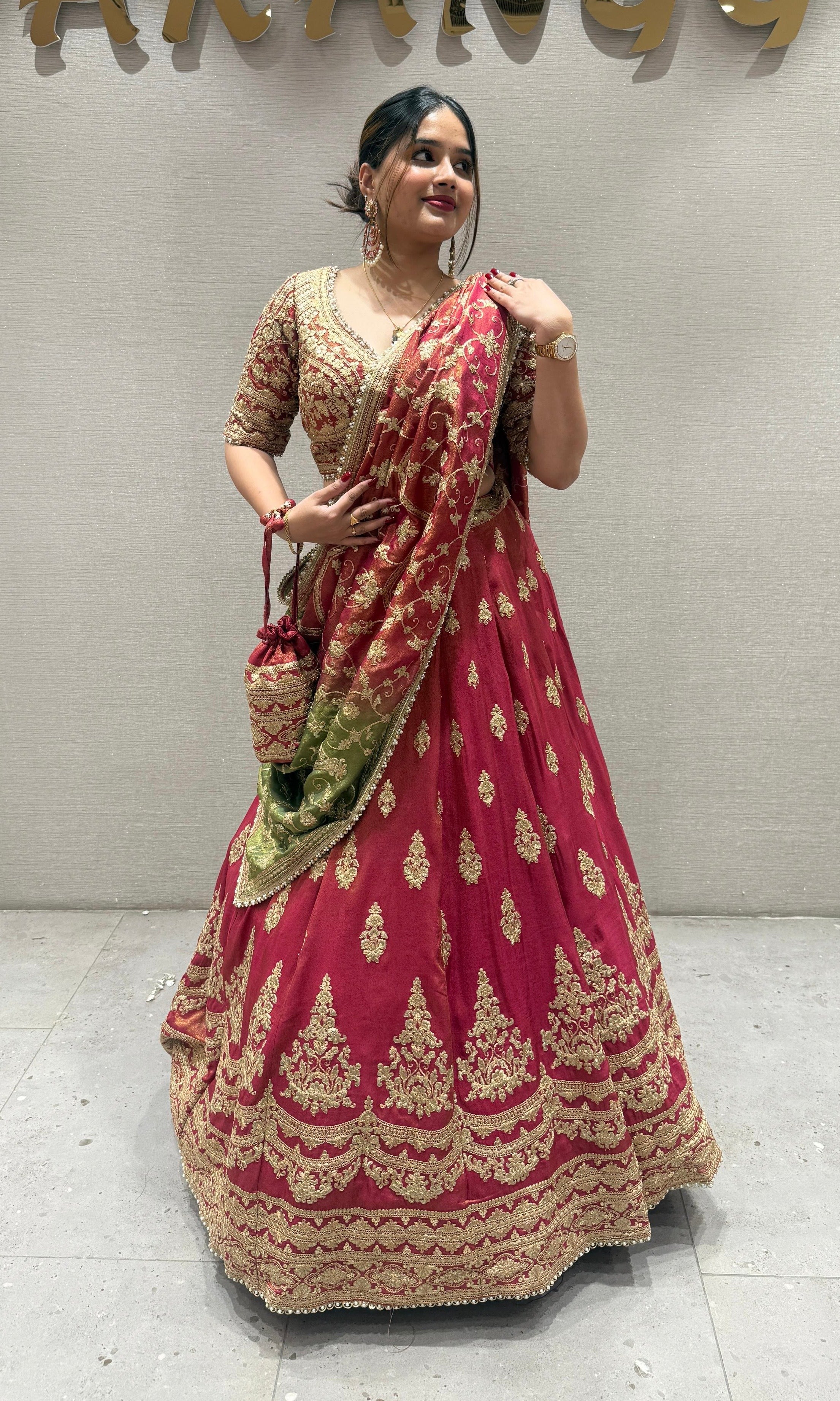 Brick red and green Lehenga with potli