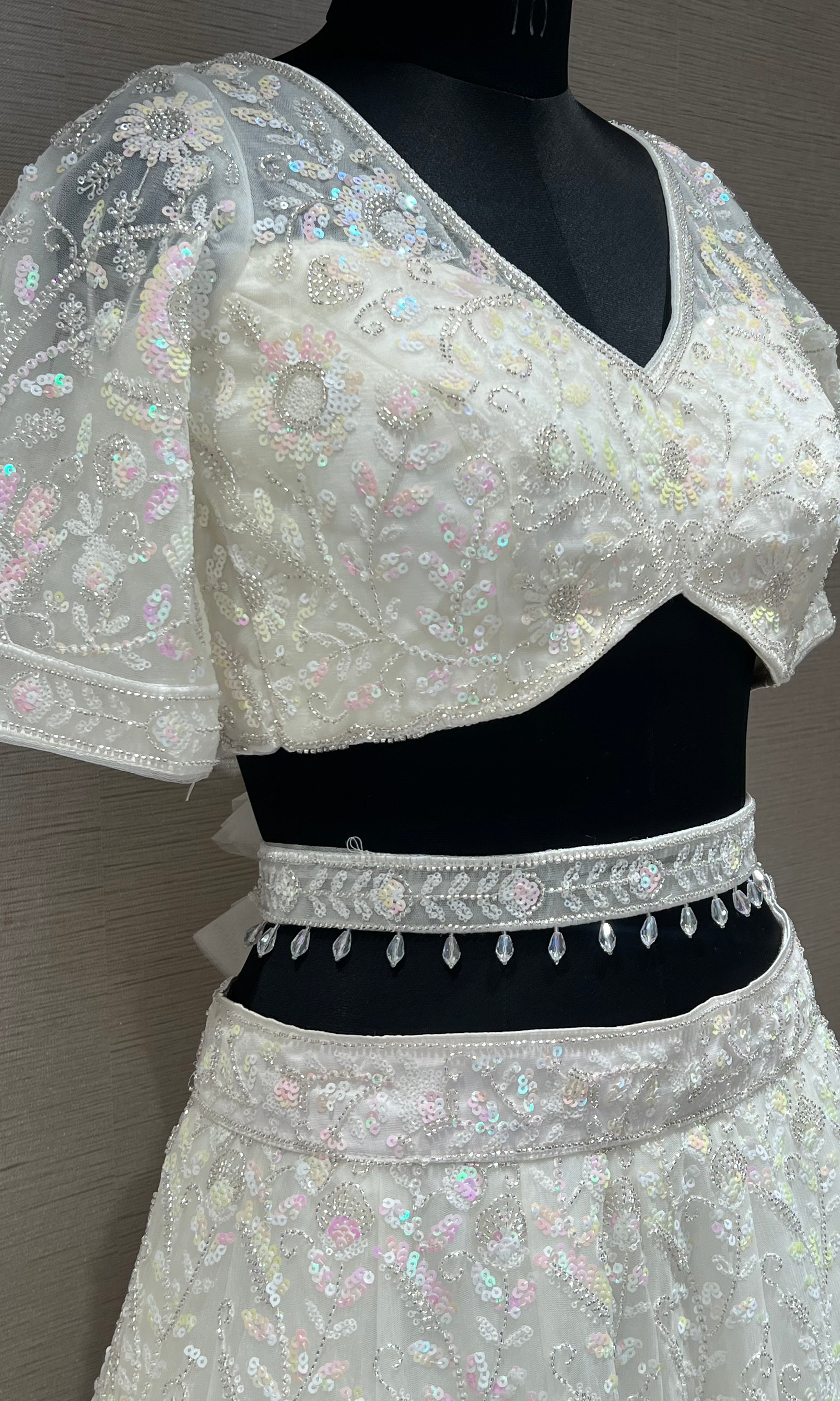 White beautiful work Lehenga with pretty blouse and netted dupatta
