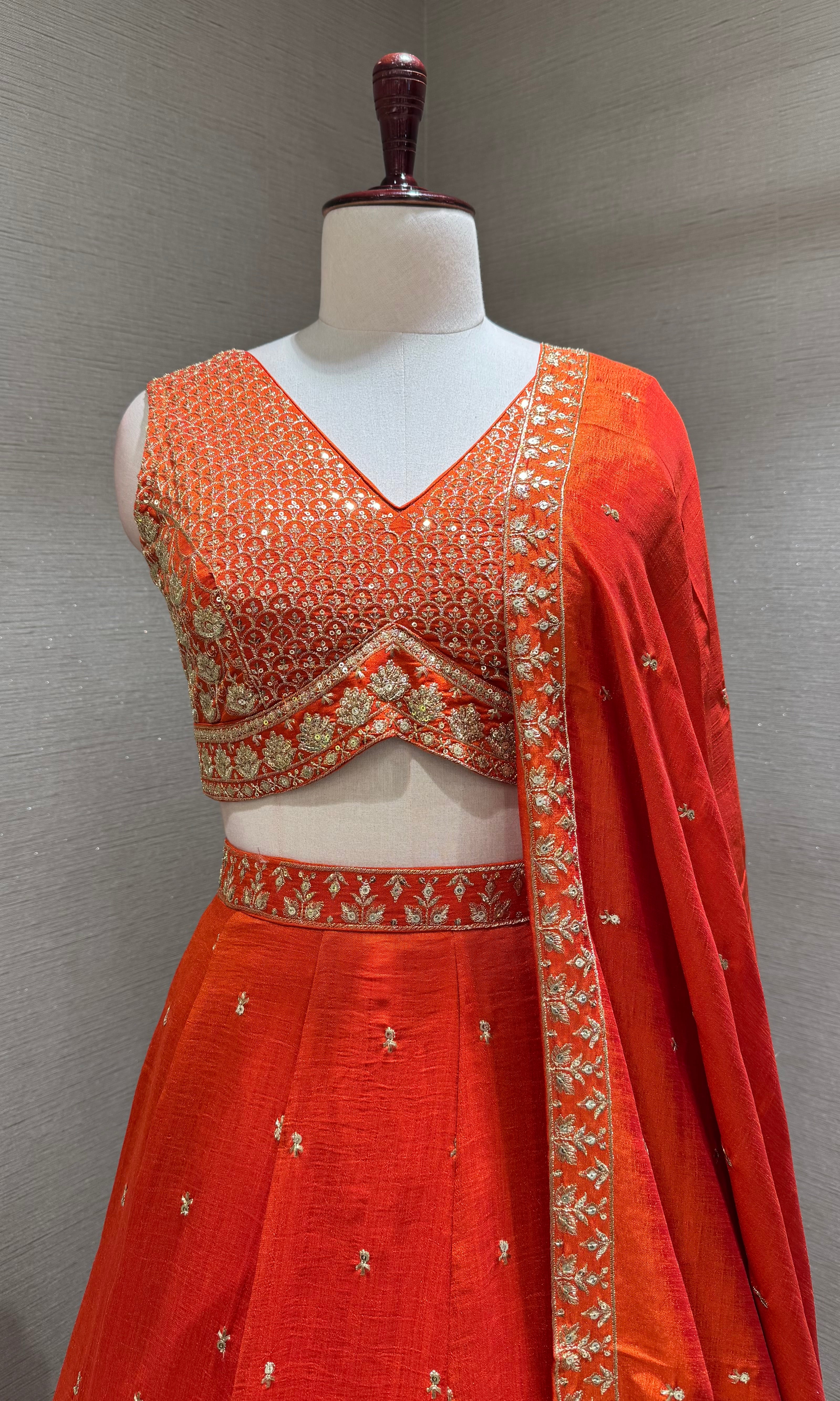 Orange Silk Lehenga Choli with Intricate Gold Borders