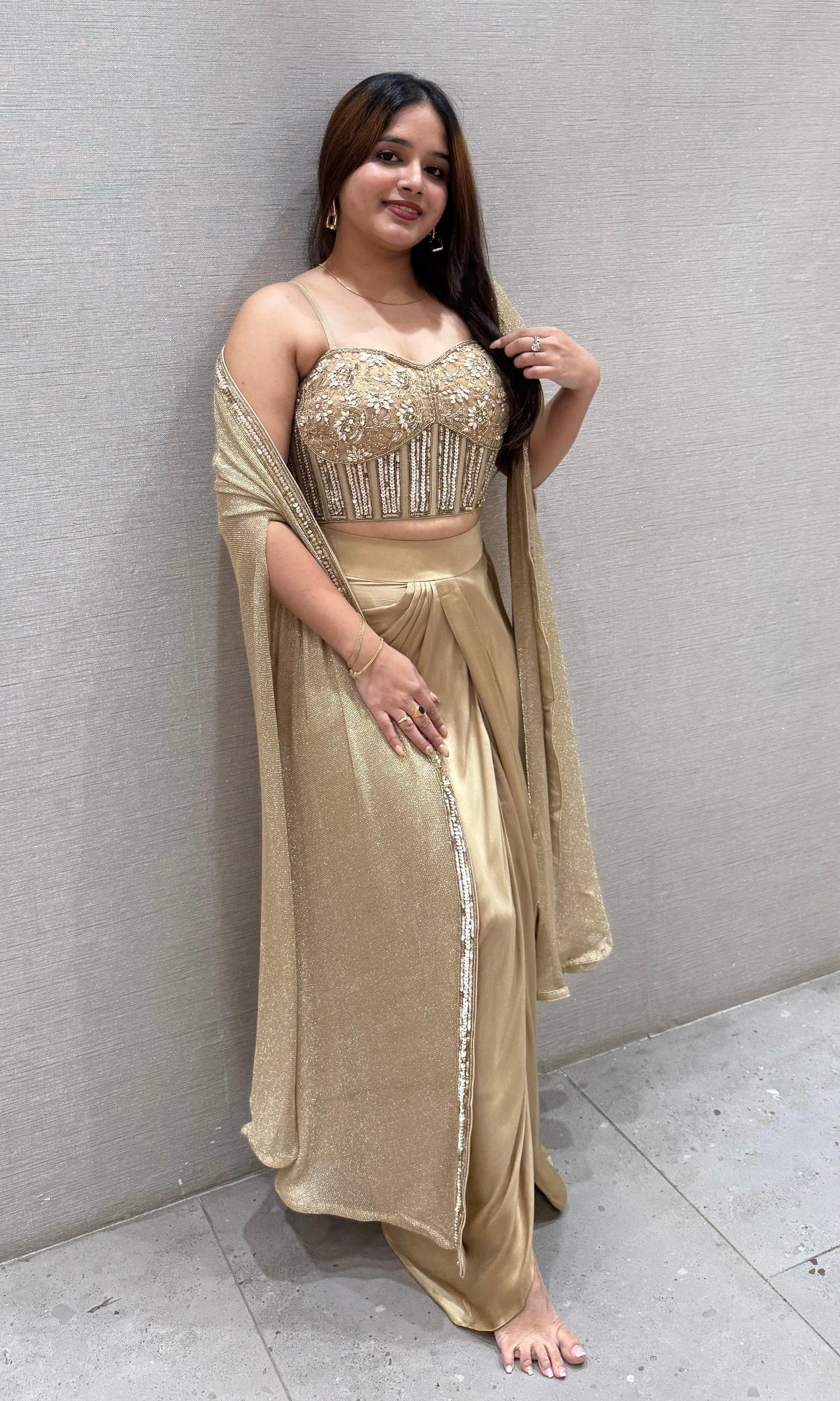 Golden sequined crop top with dhoti skirt and cape