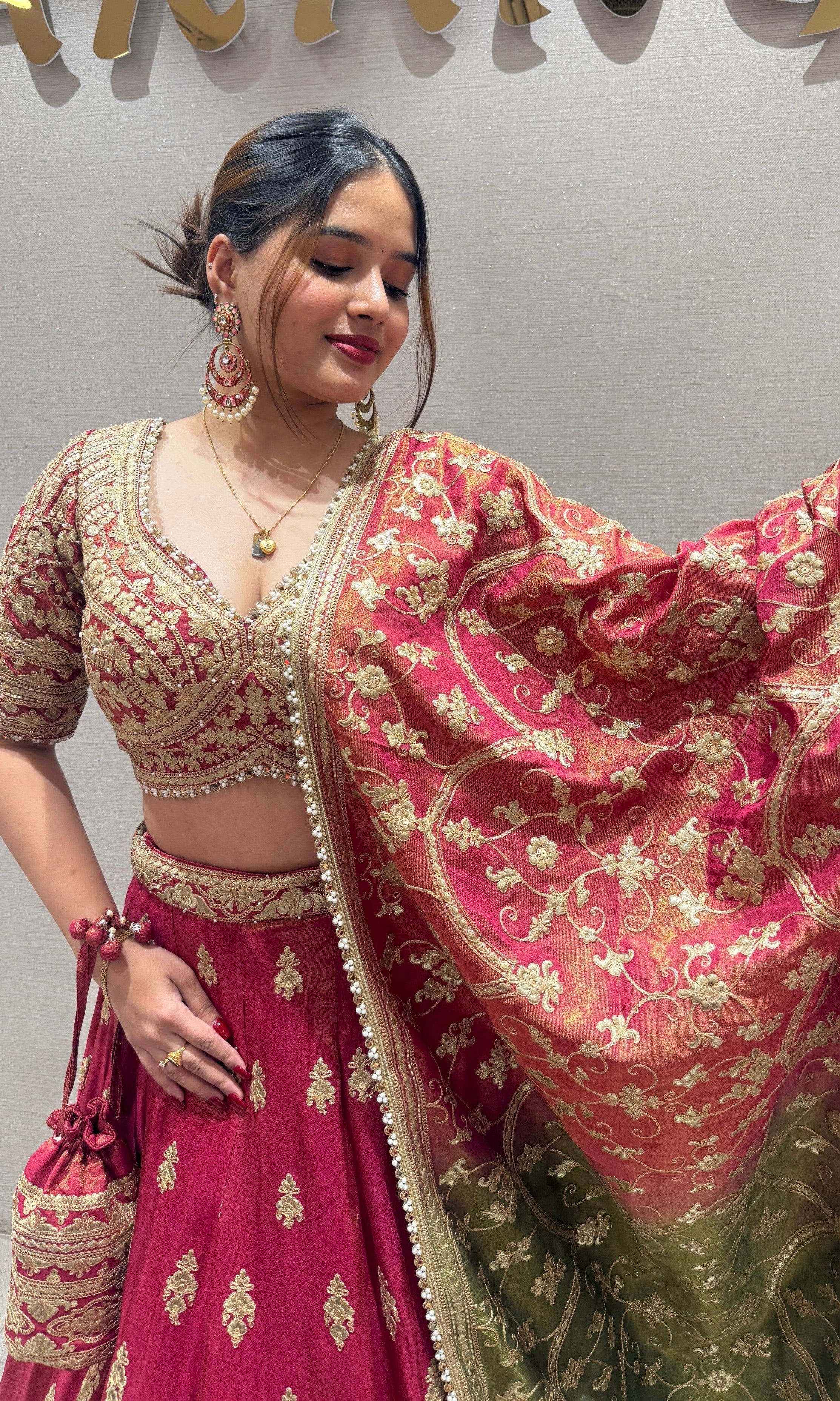 Brick red and green Lehenga with potli