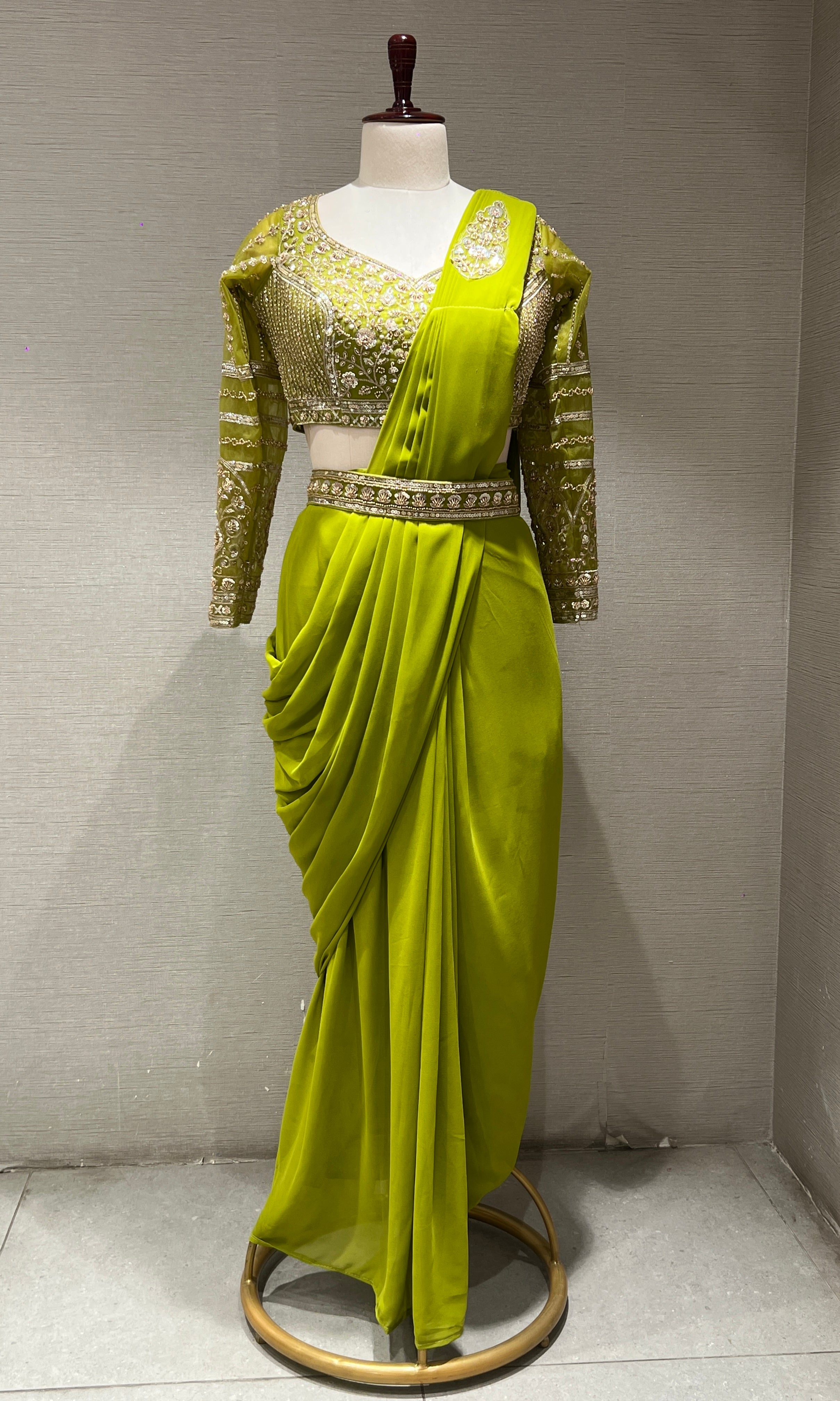 green draped saree with embellished blouse