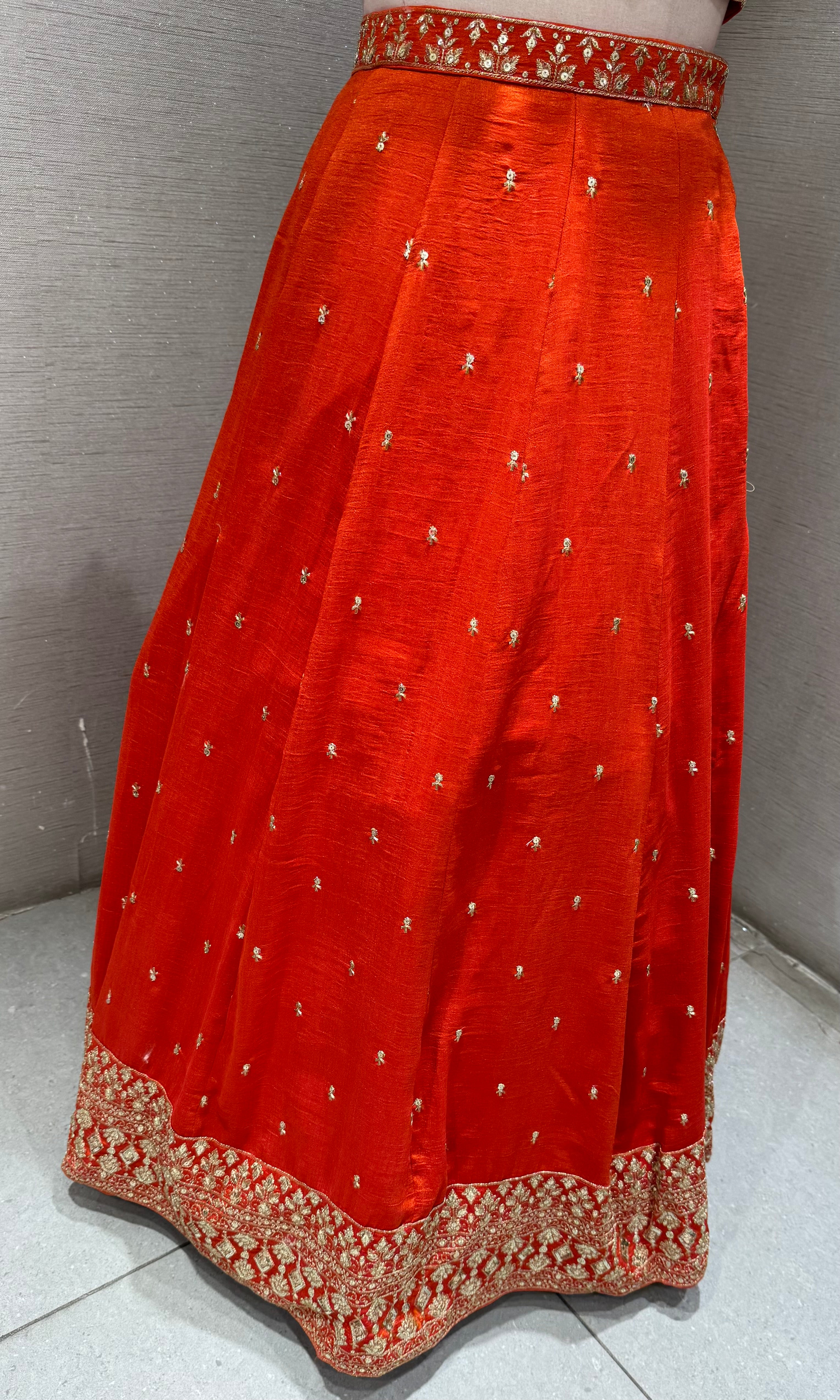 Orange Silk Lehenga Choli with Intricate Gold Borders