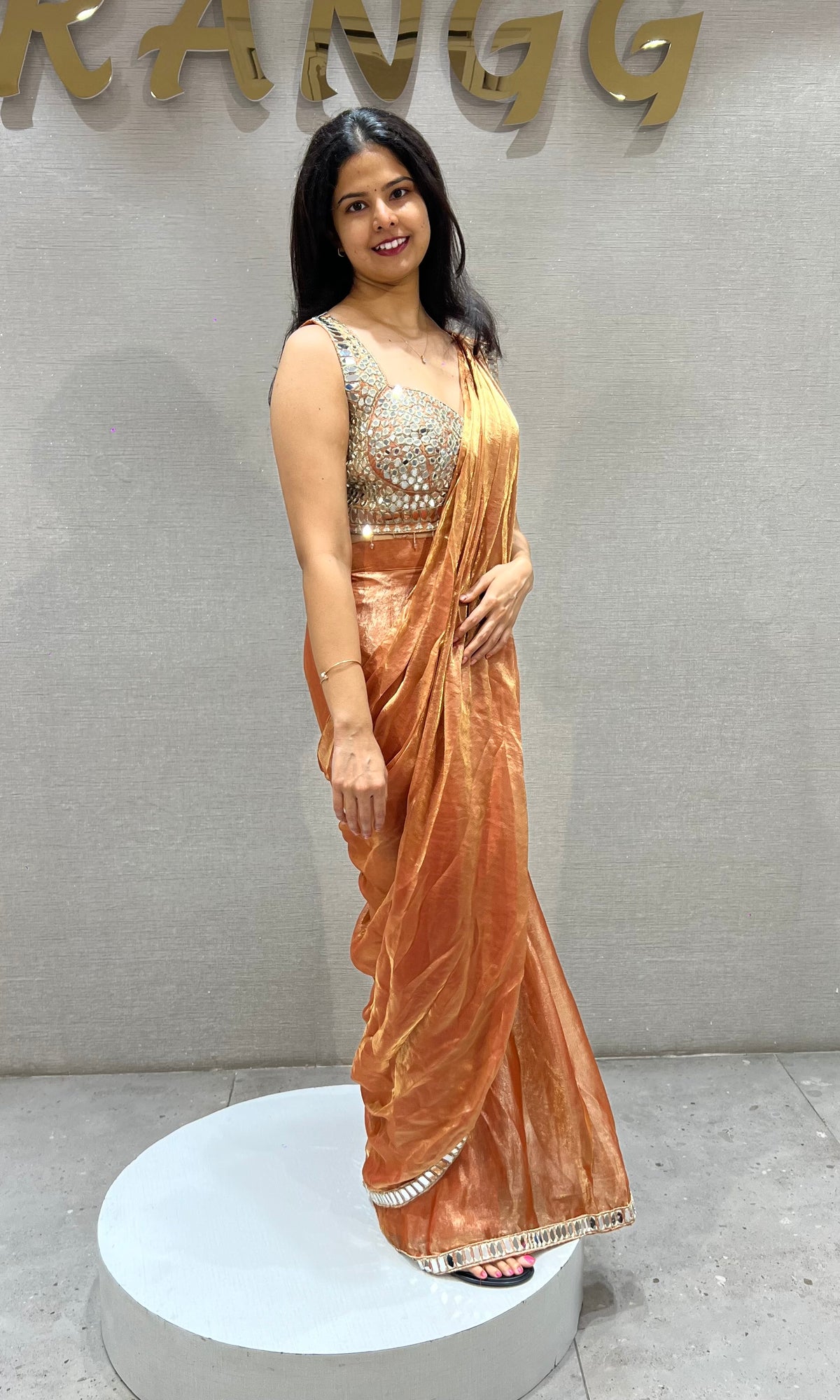 Rust Shimmer Drape Saree with mirror embellished blouse