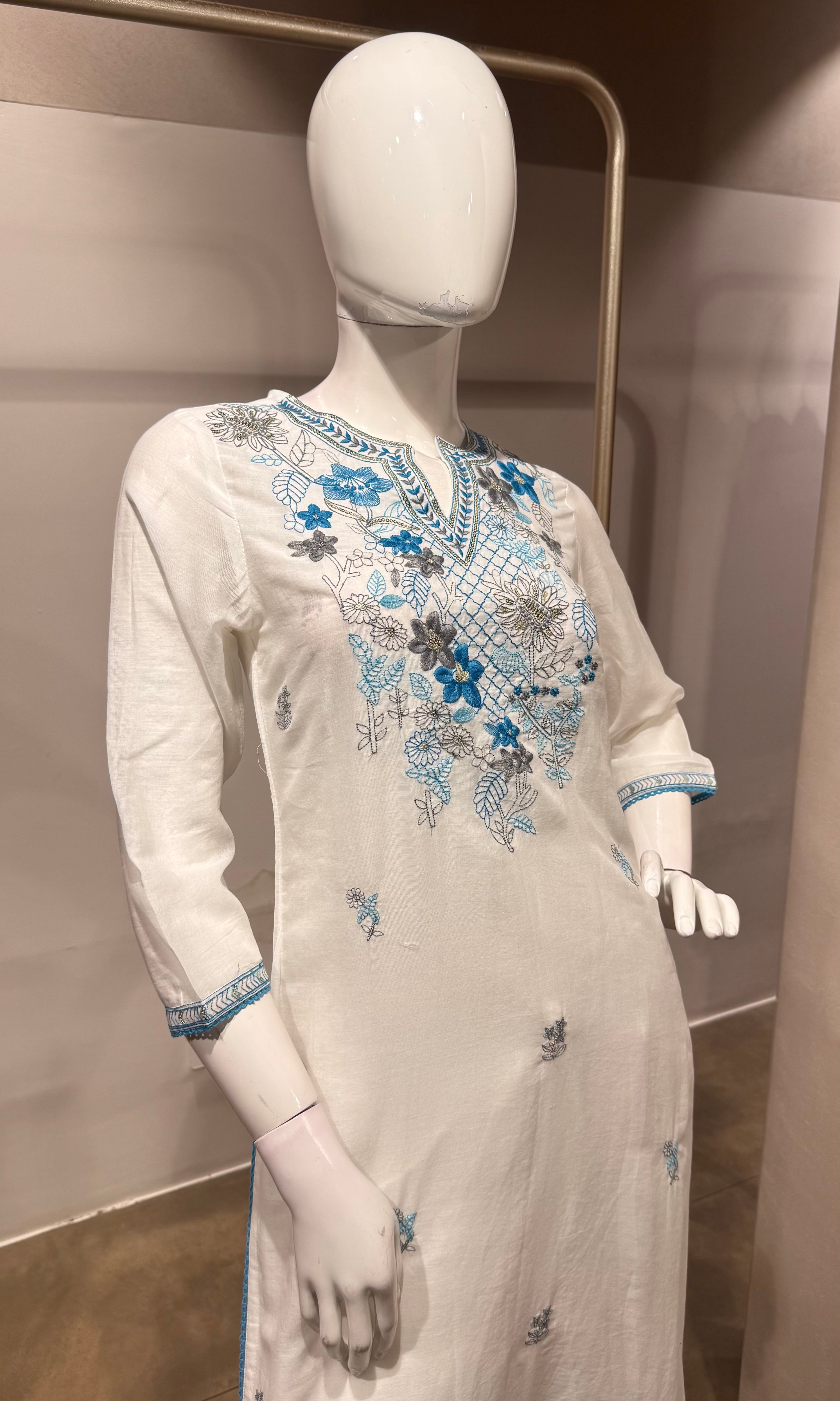 white kurta set features blue floral embroidery