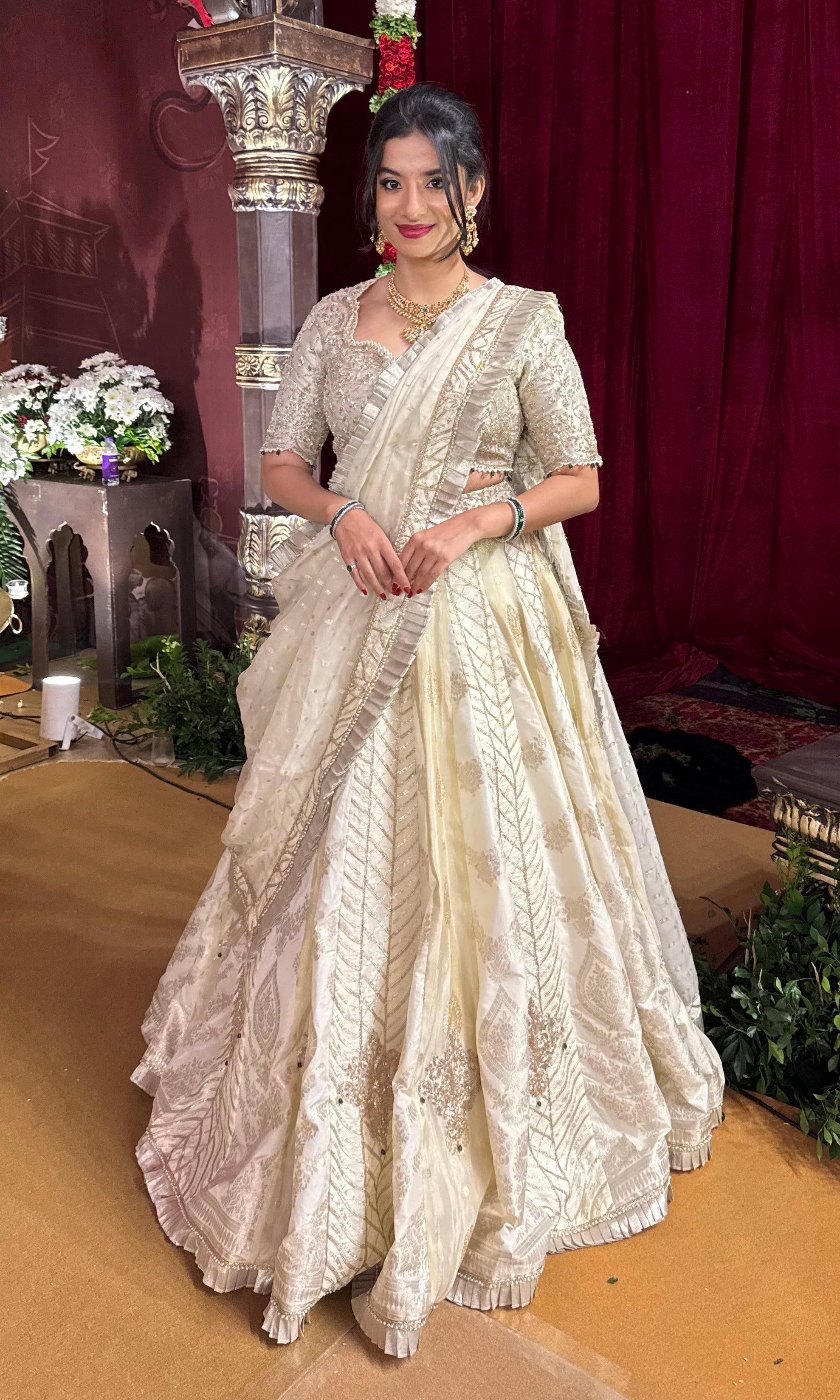 Ivory white gold lehenga with emerald greed beads