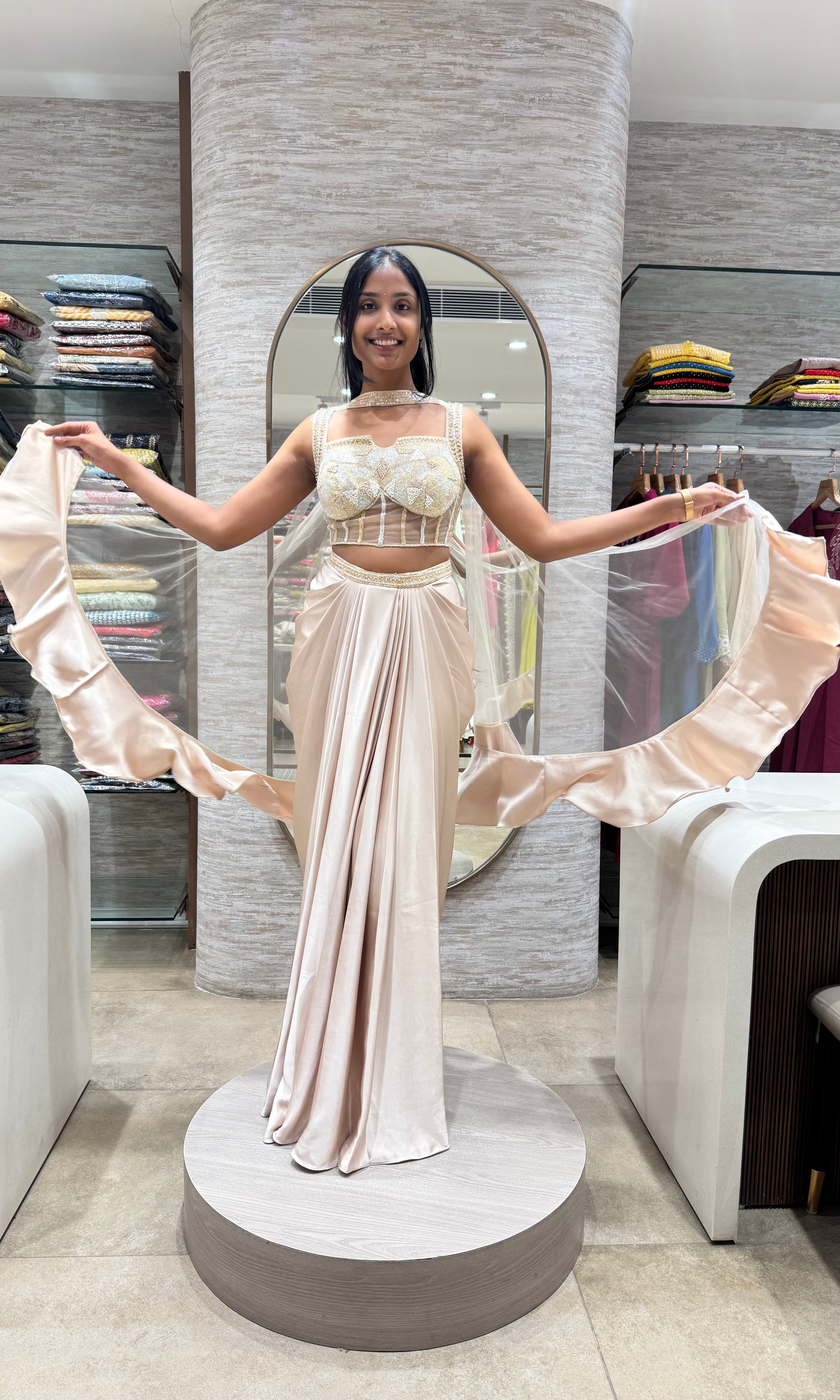 half white drape saree with corset blouse and cape