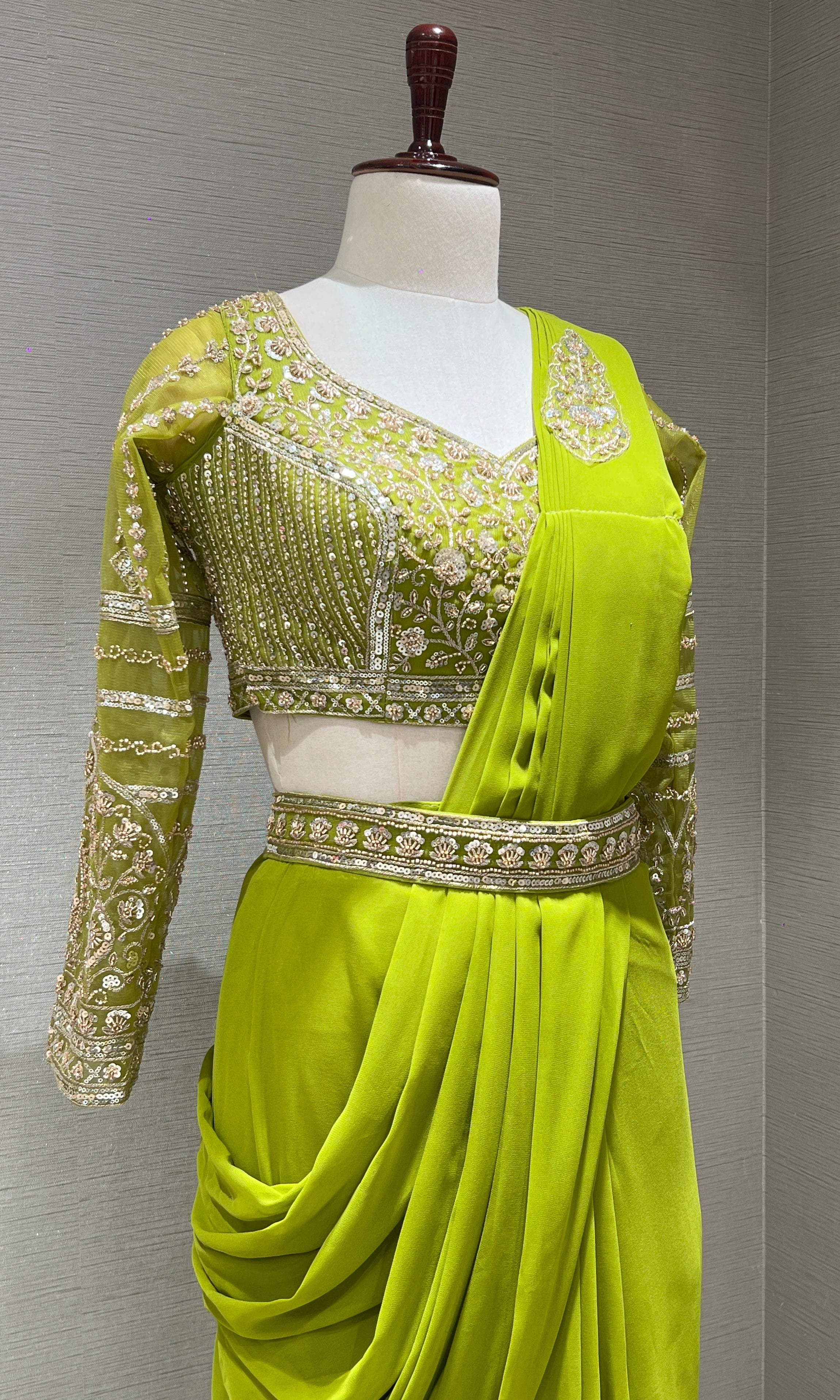 green draped saree with embellished blouse