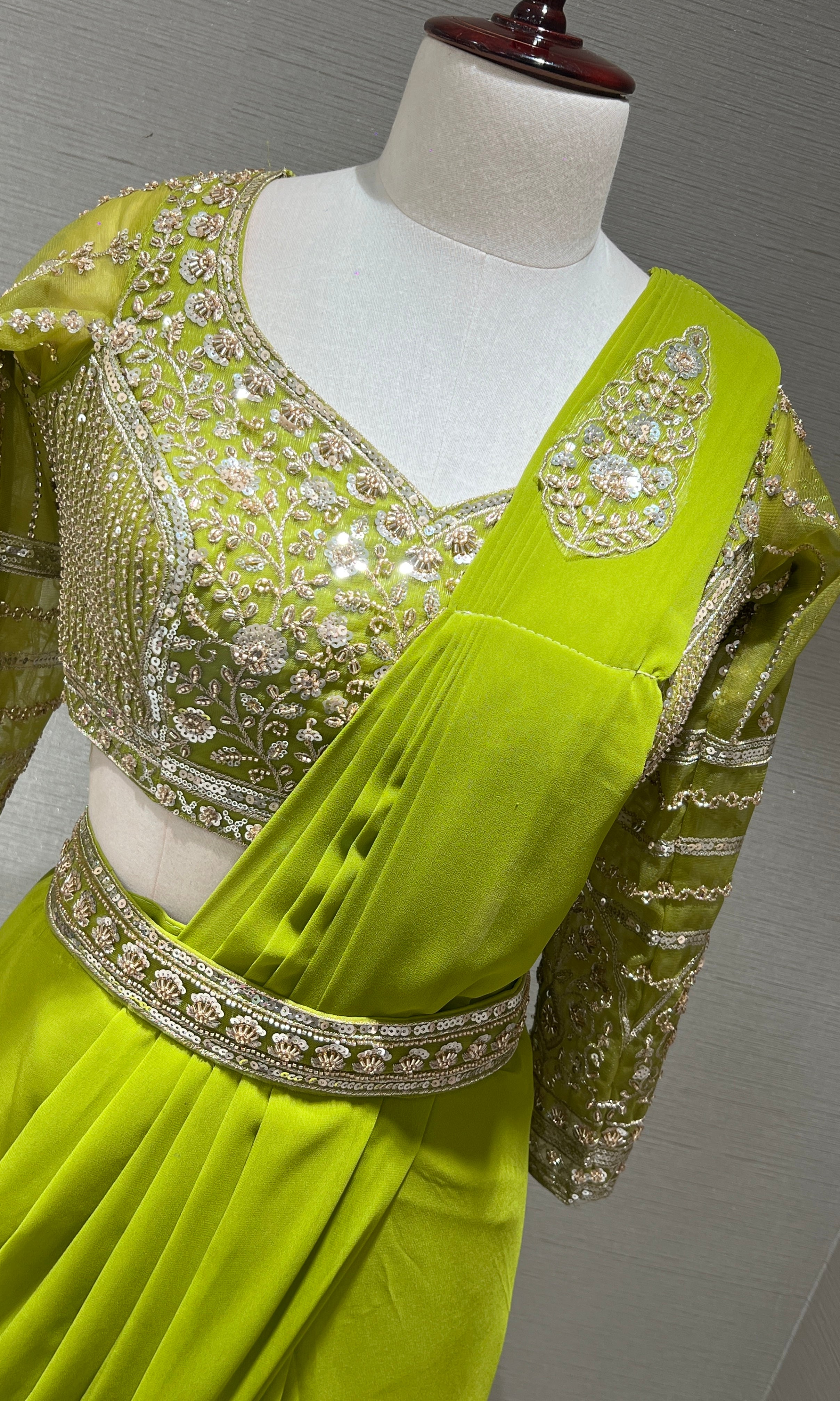 green draped saree with embellished blouse