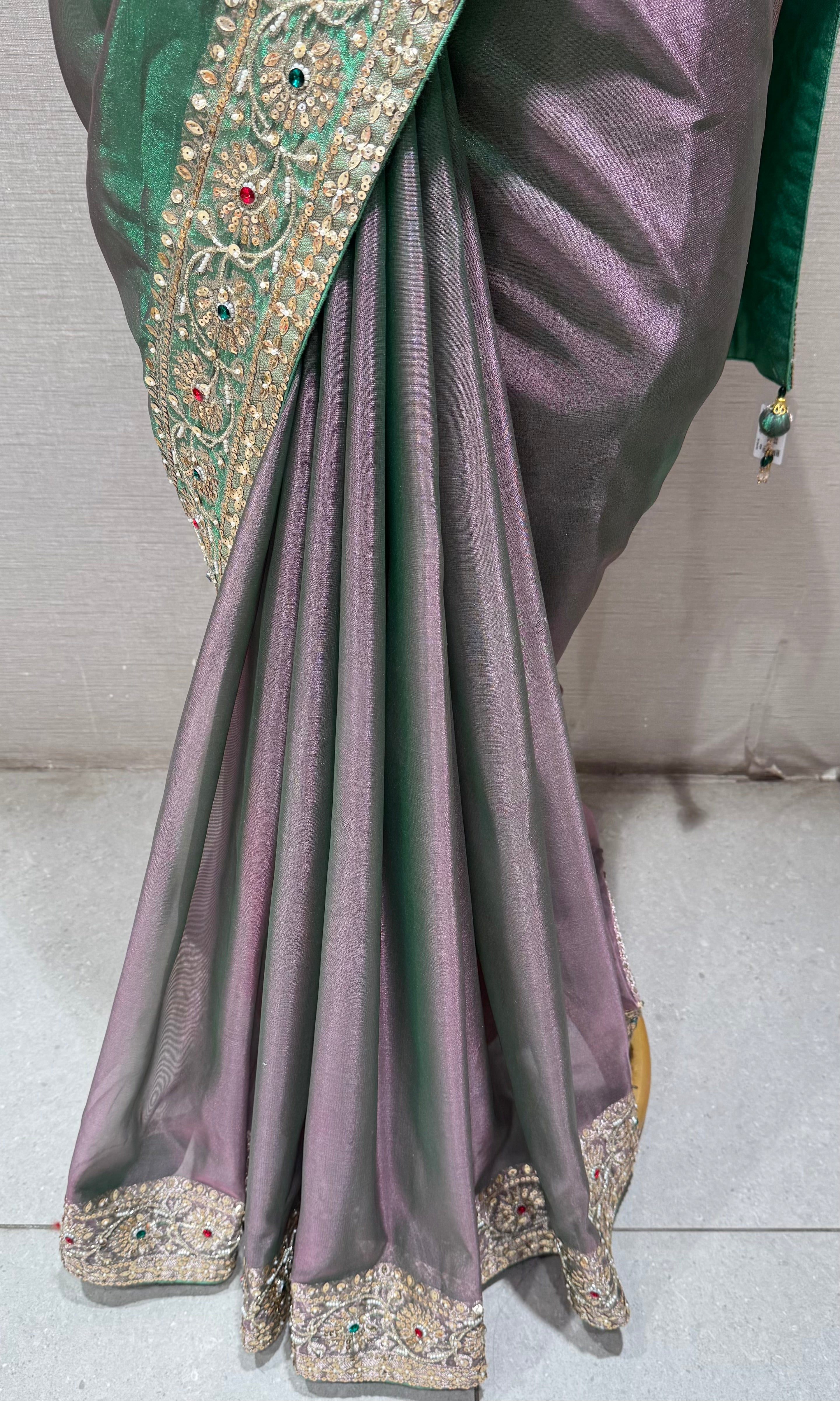 green silk blend saree with an embellished blouse