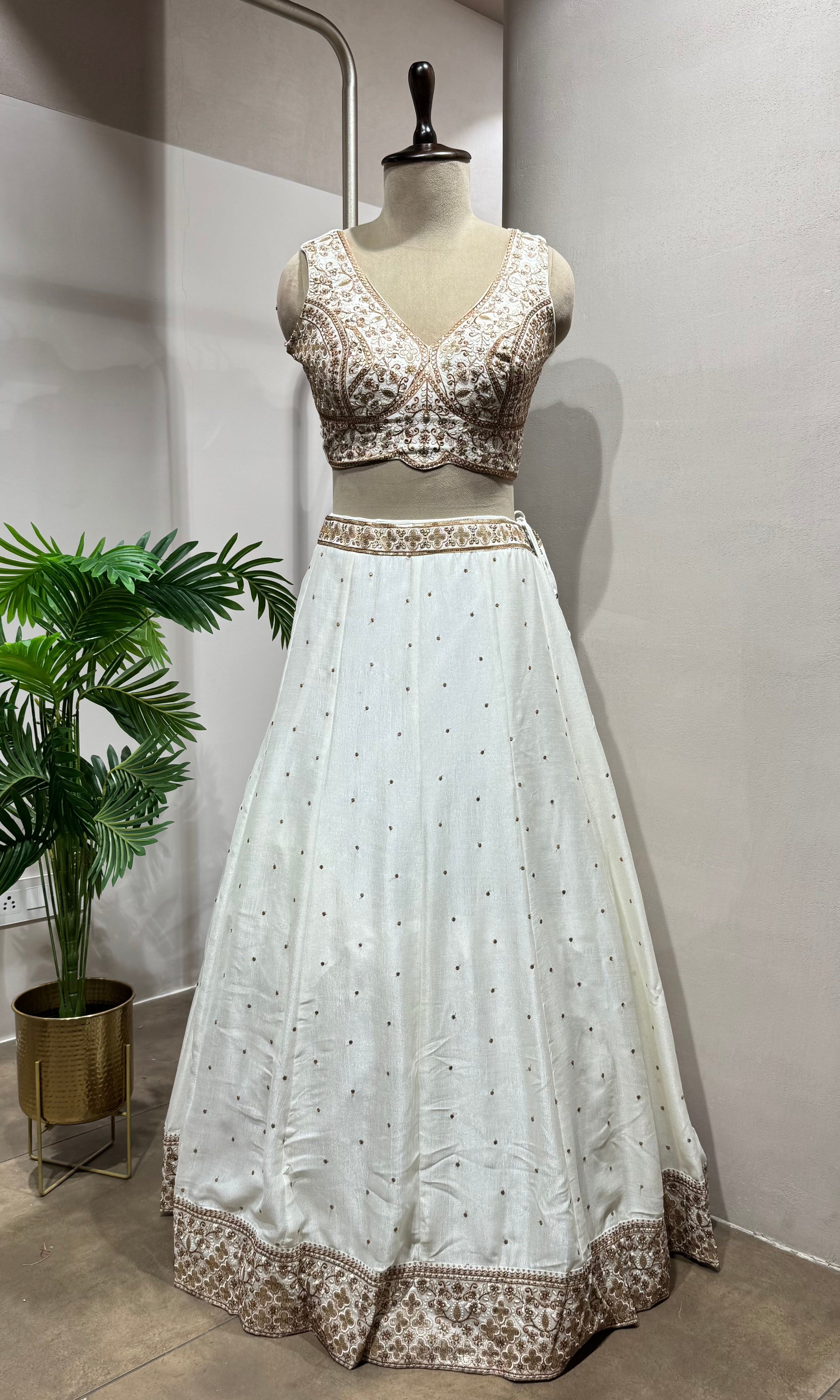 White Lehenga with gold embellished blouse