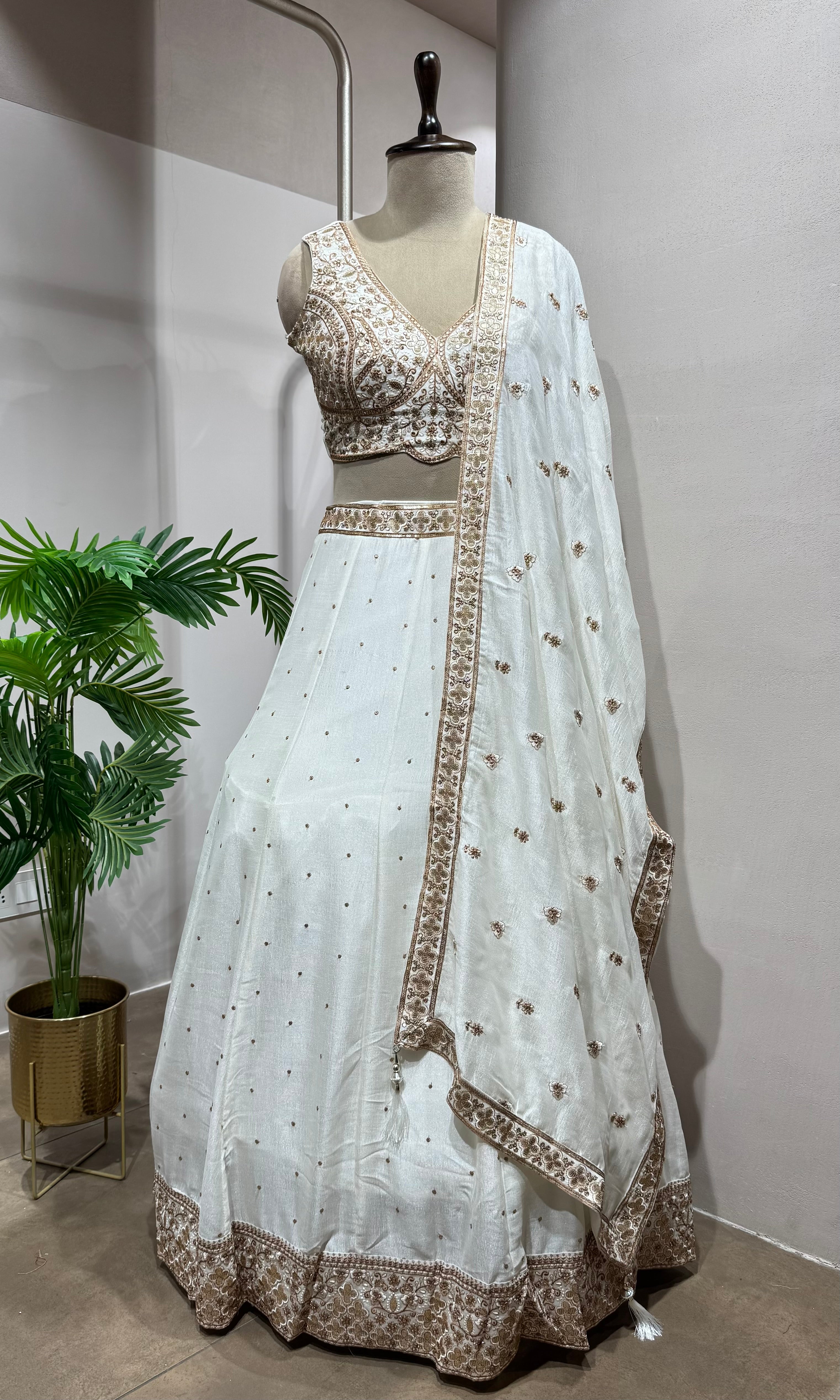 White Lehenga with gold embellished blouse