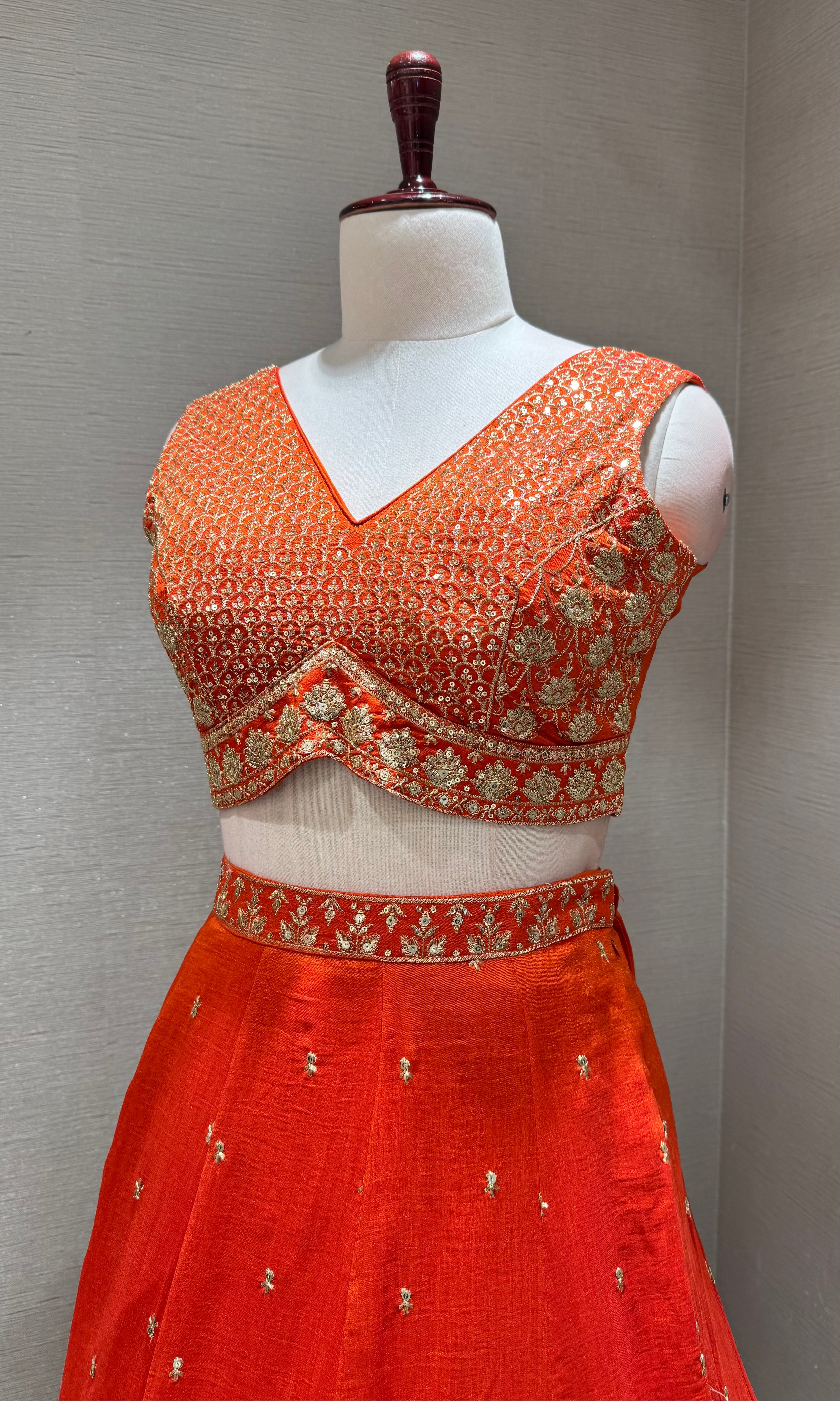 Orange Silk Lehenga Choli with Intricate Gold Borders