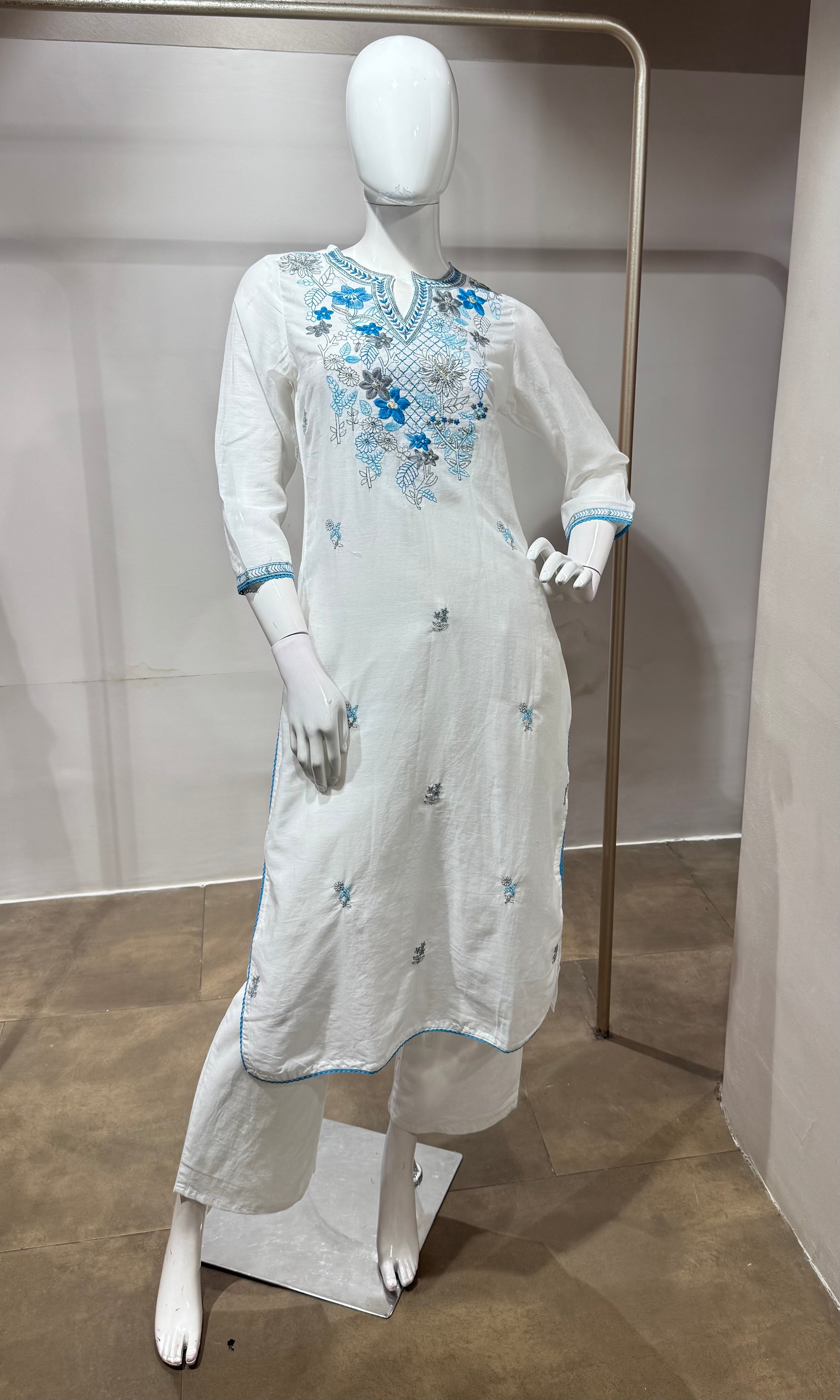 white kurta set features blue floral embroidery
