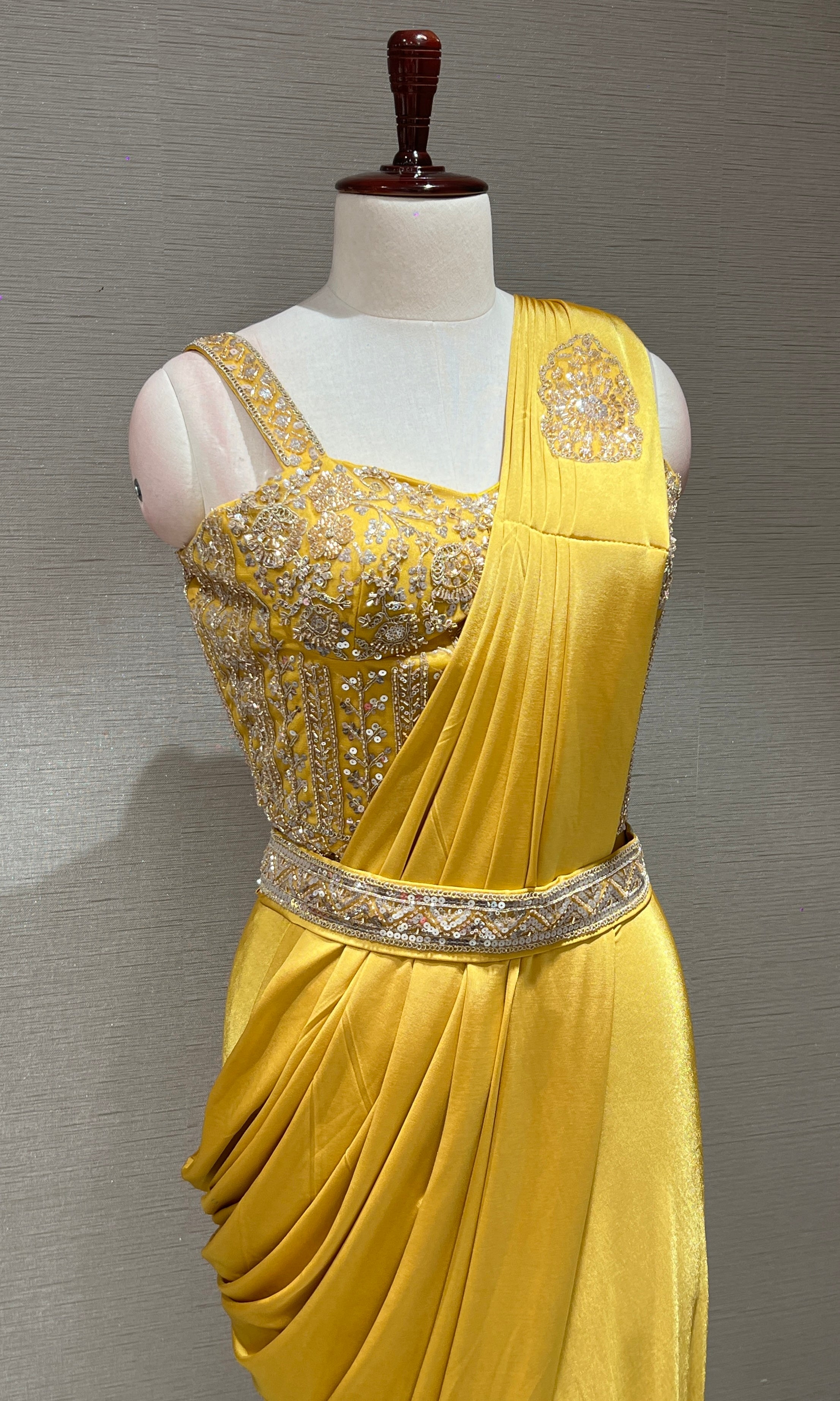 yellow drape saree with corset blouse and belt