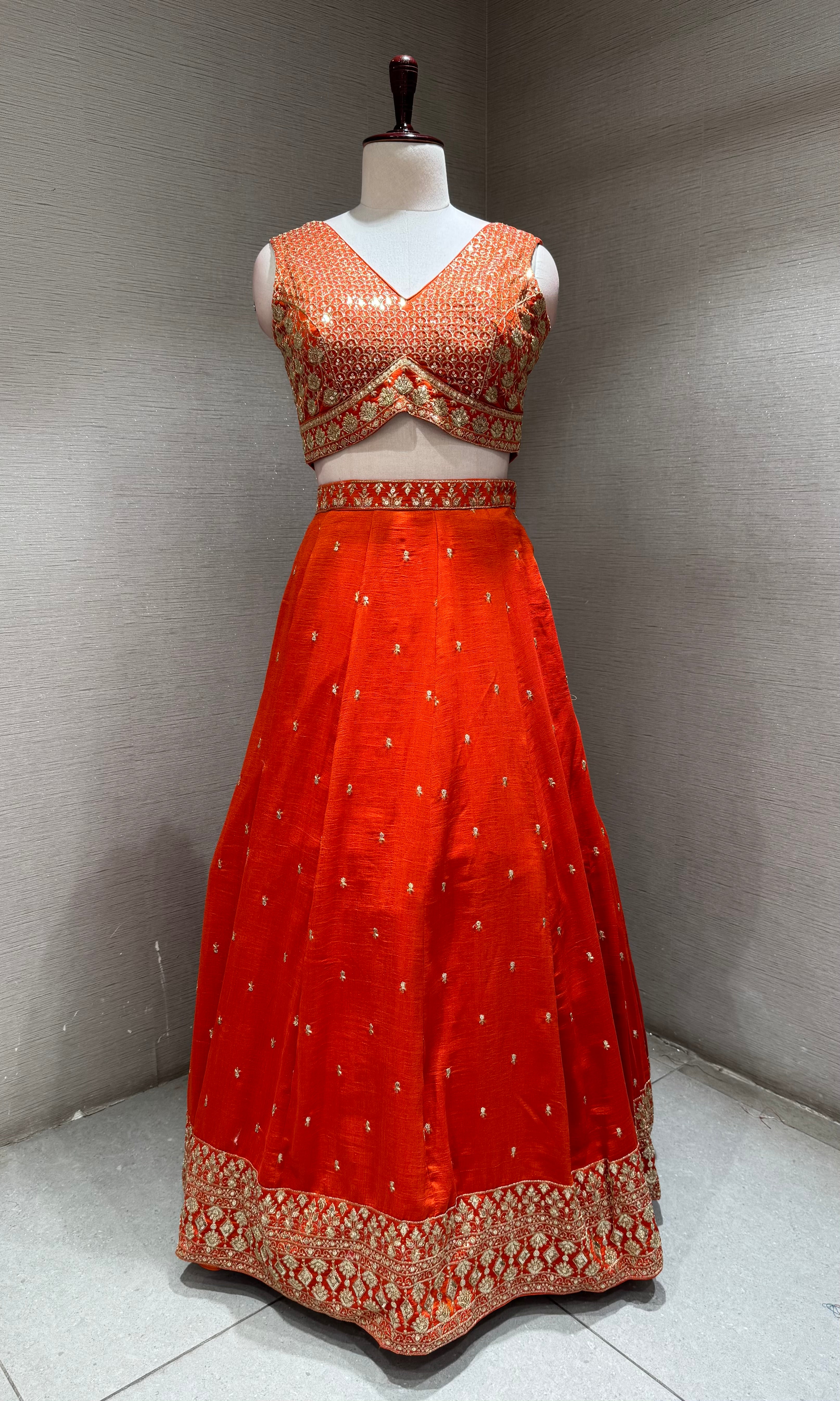 Orange Silk Lehenga Choli with Intricate Gold Borders