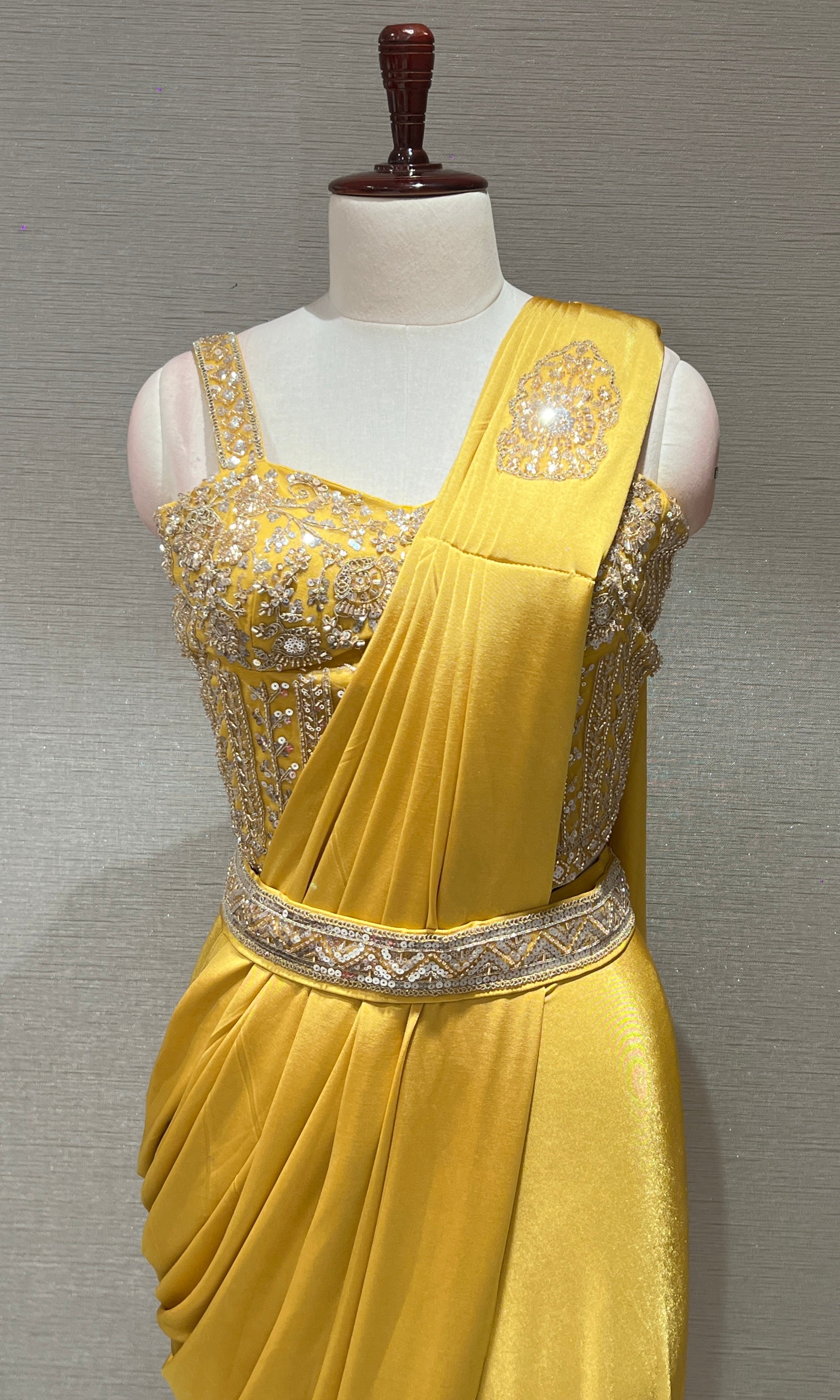yellow drape saree with corset blouse and belt