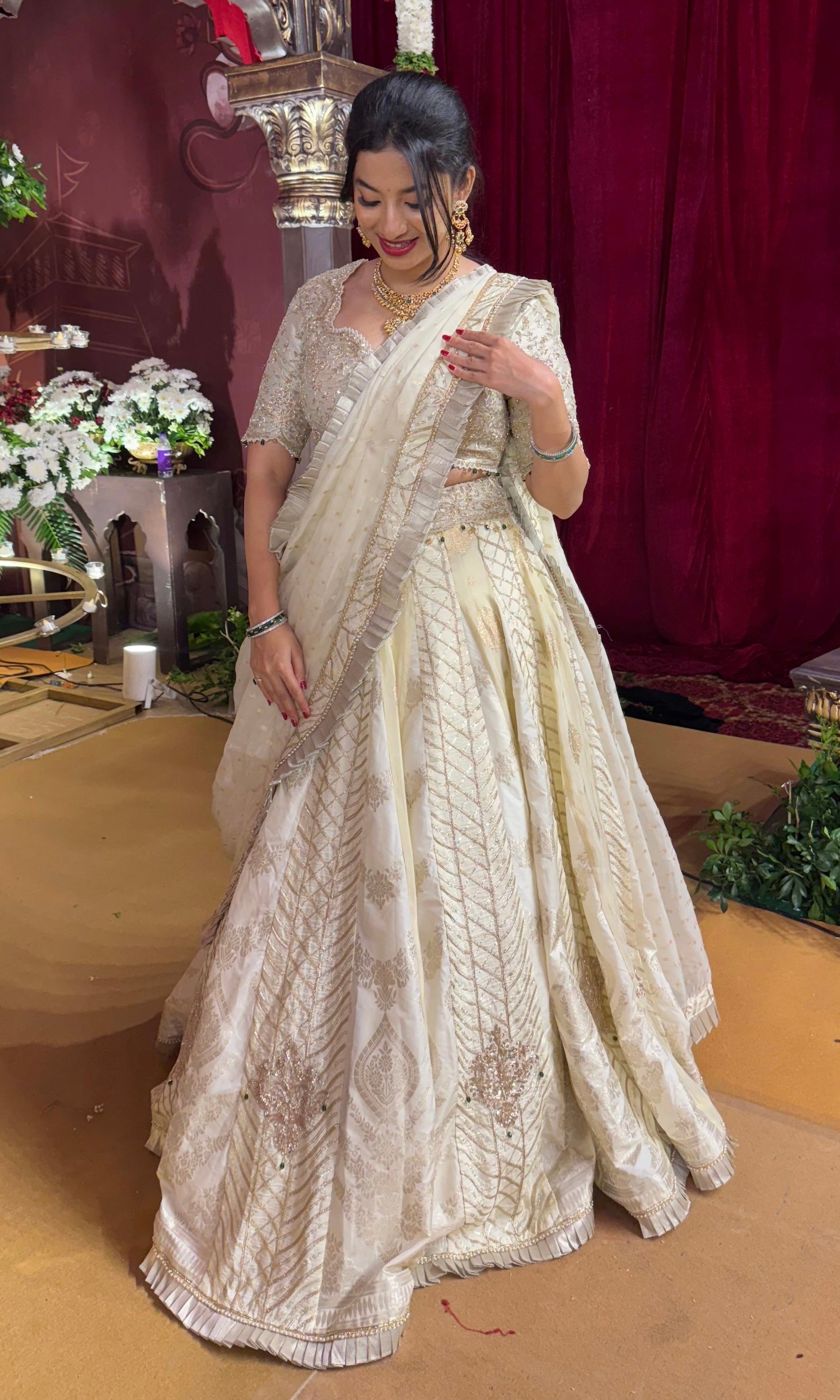 Ivory white gold lehenga with emerald greed beads