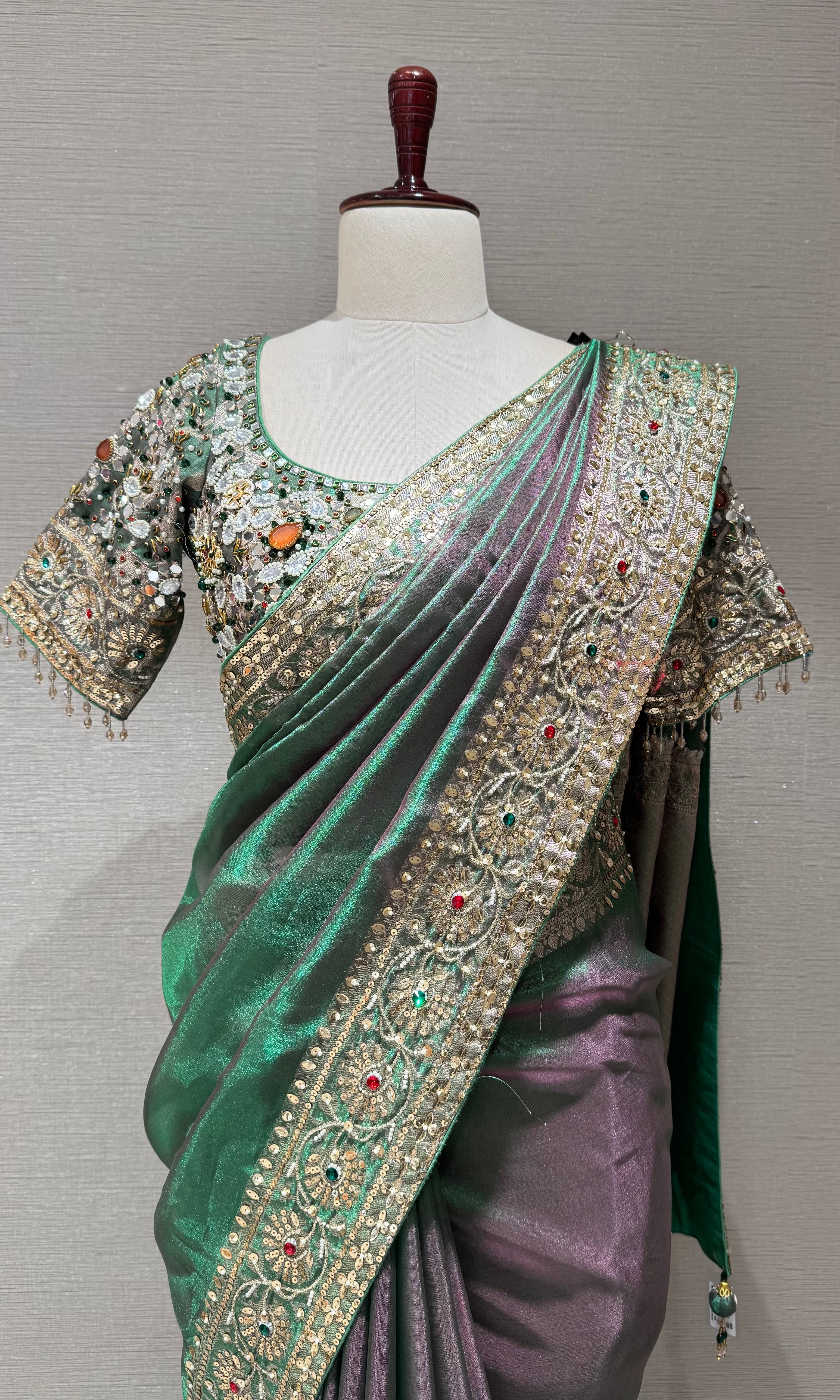 green silk blend saree with an embellished blouse
