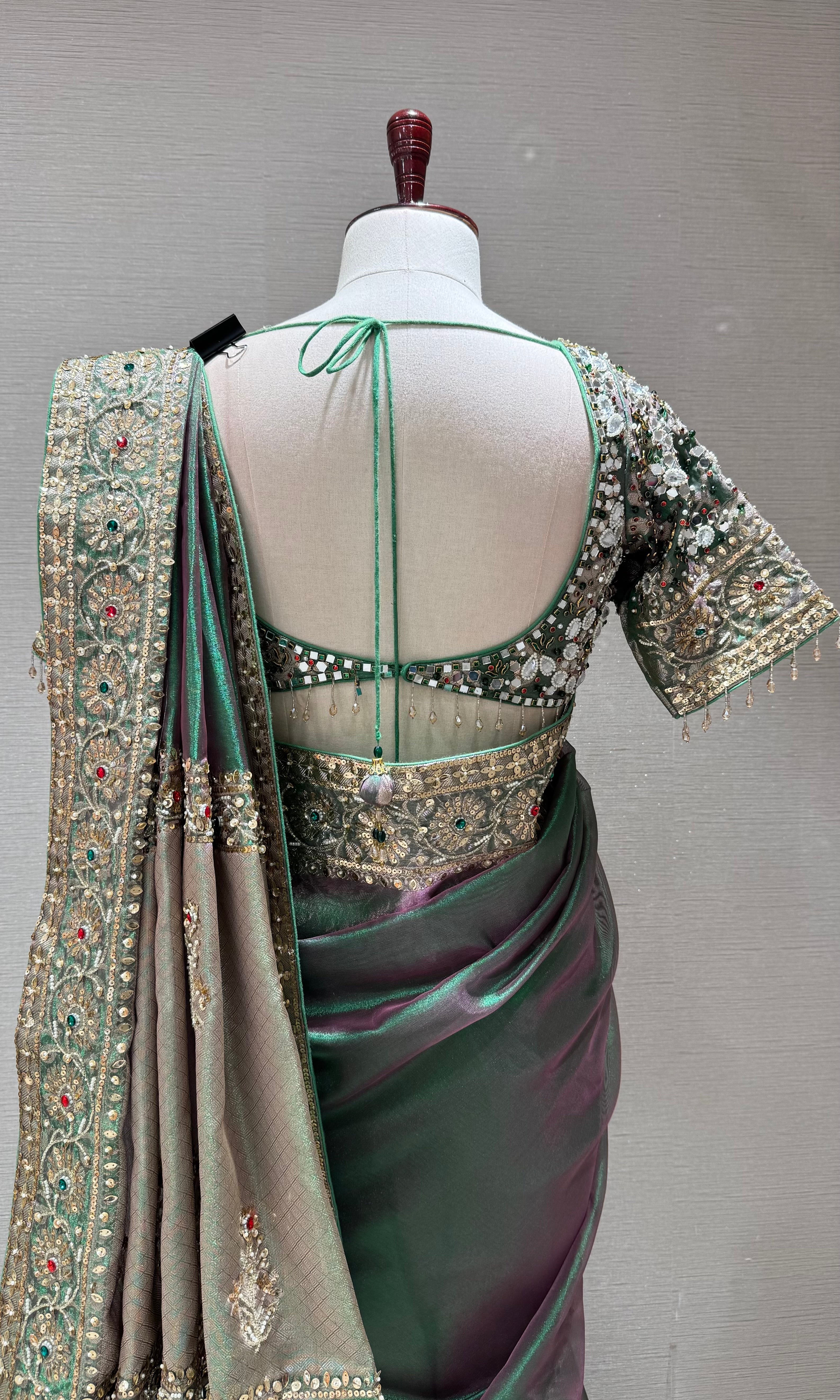 green silk blend saree with an embellished blouse